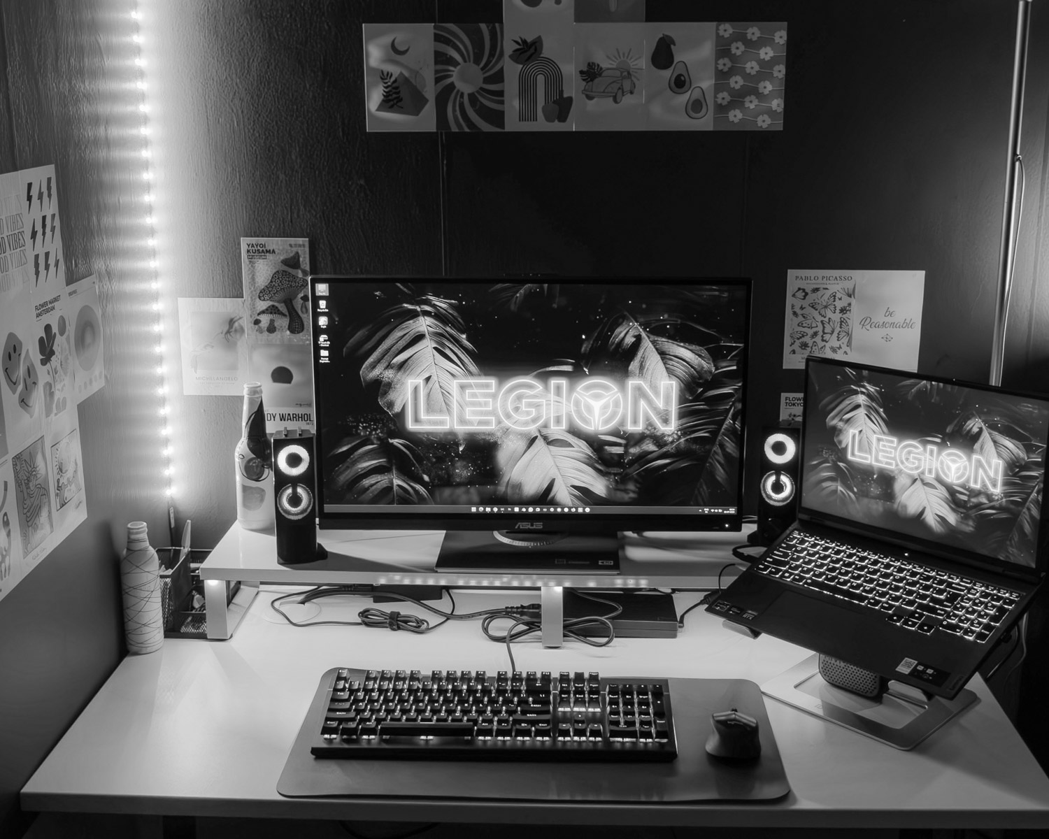a desk with a laptop and a monitor on it