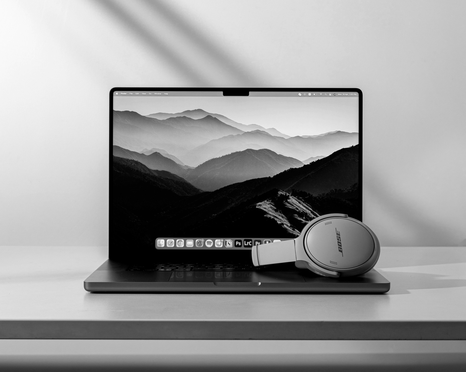 a laptop with a pair of headphones sitting on top of it