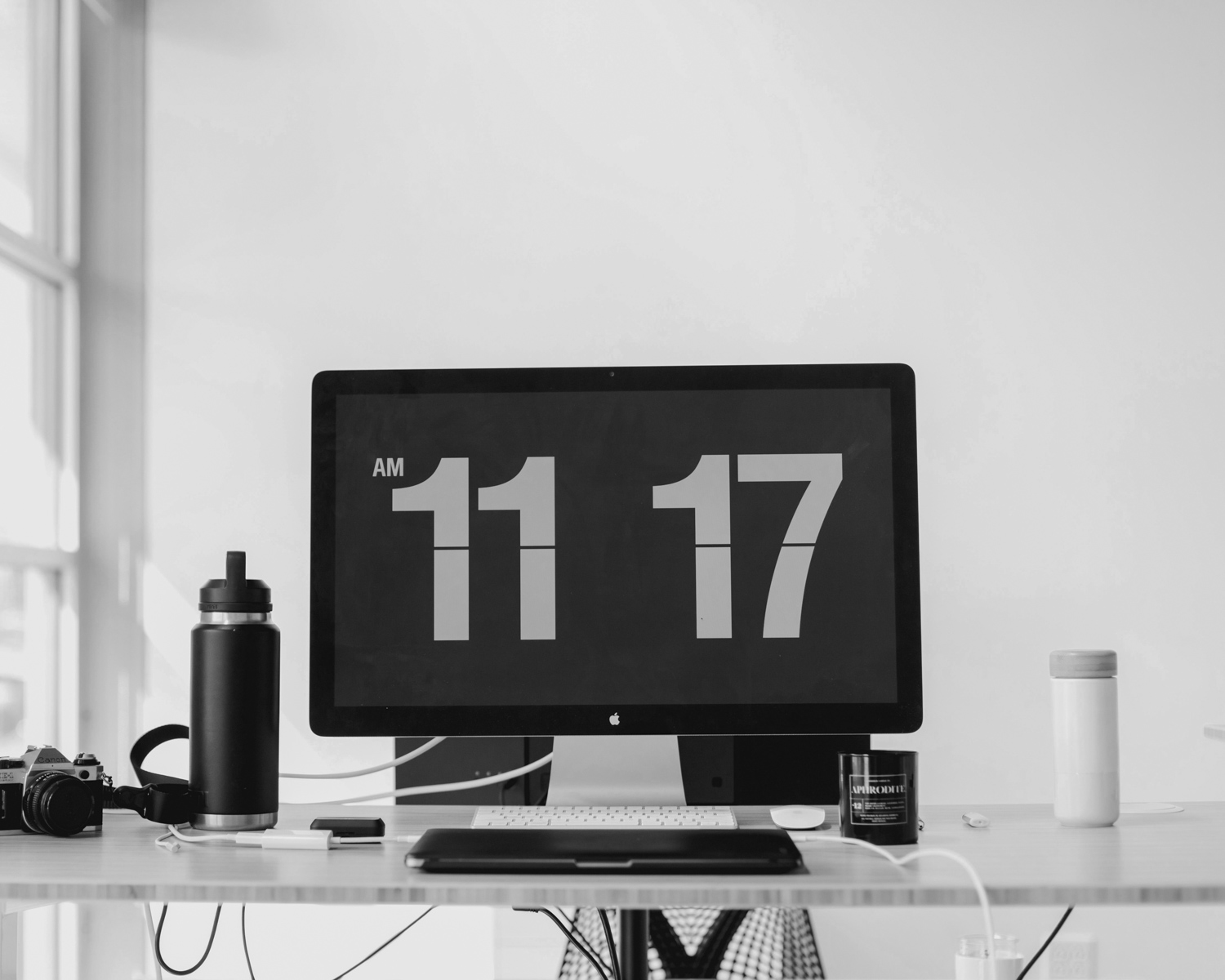 black flat screen computer monitor on brown wooden desk