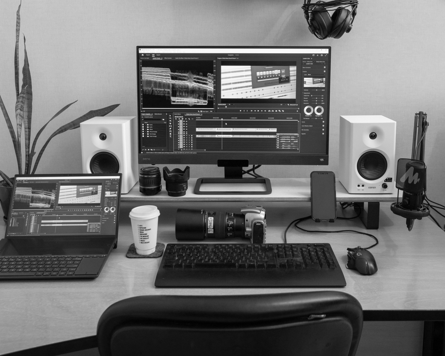 A desk with a computer and speakers on it