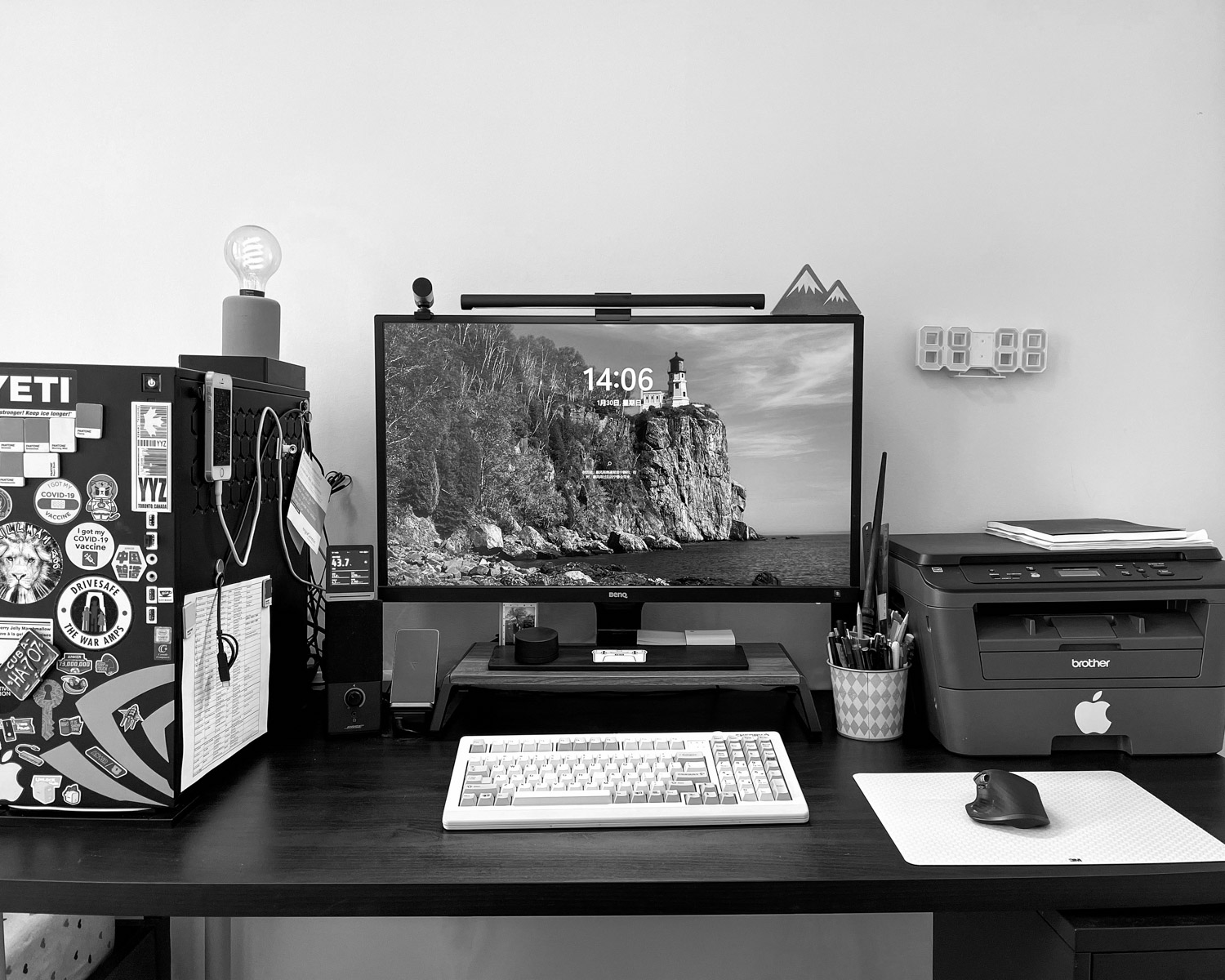 a desk with a computer and printer on it