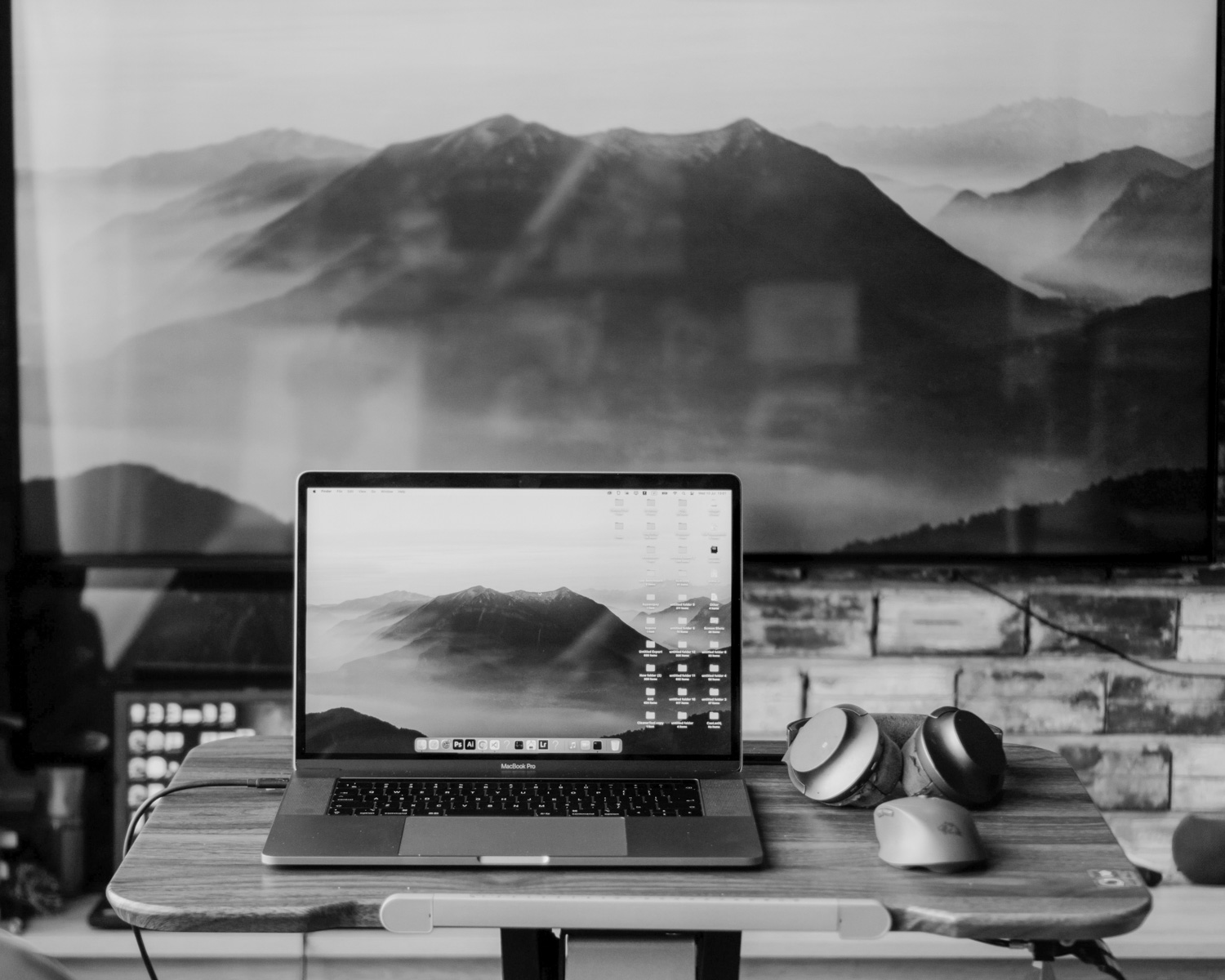 Modern workspace with a laptop and mountain view.