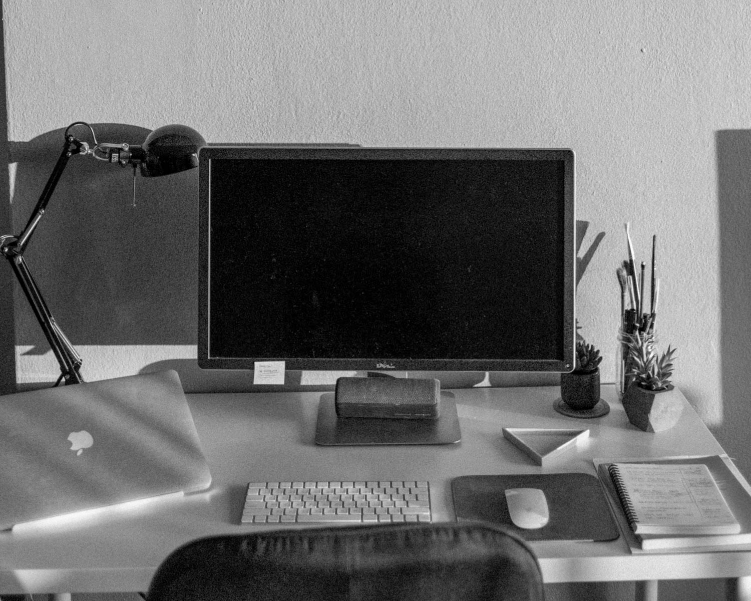 black flat screen computer monitor on brown wooden desk