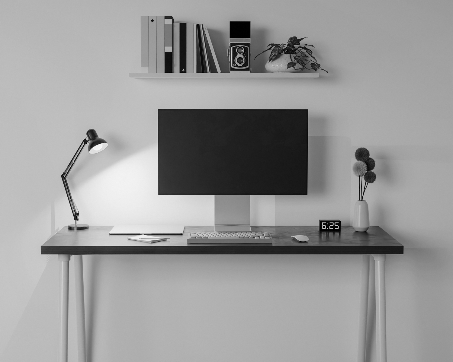 a desk with a computer and a lamp on it