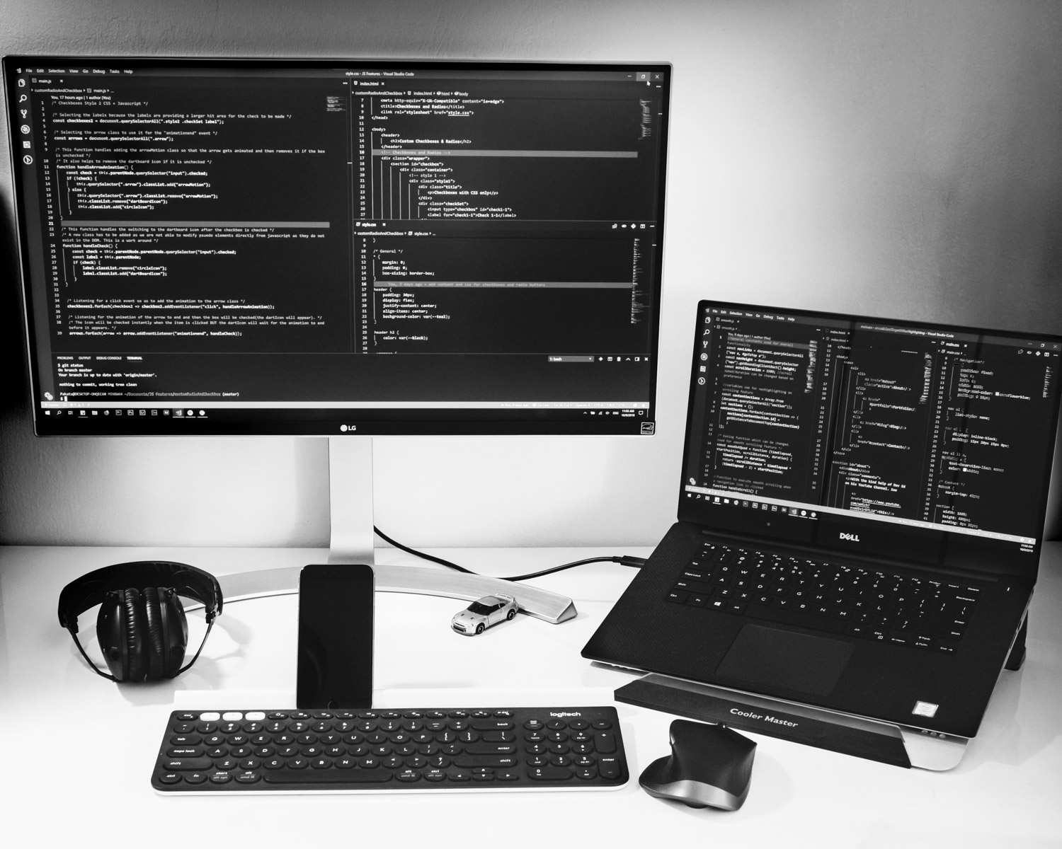laptop computer beside monitor with keyboard and mouse