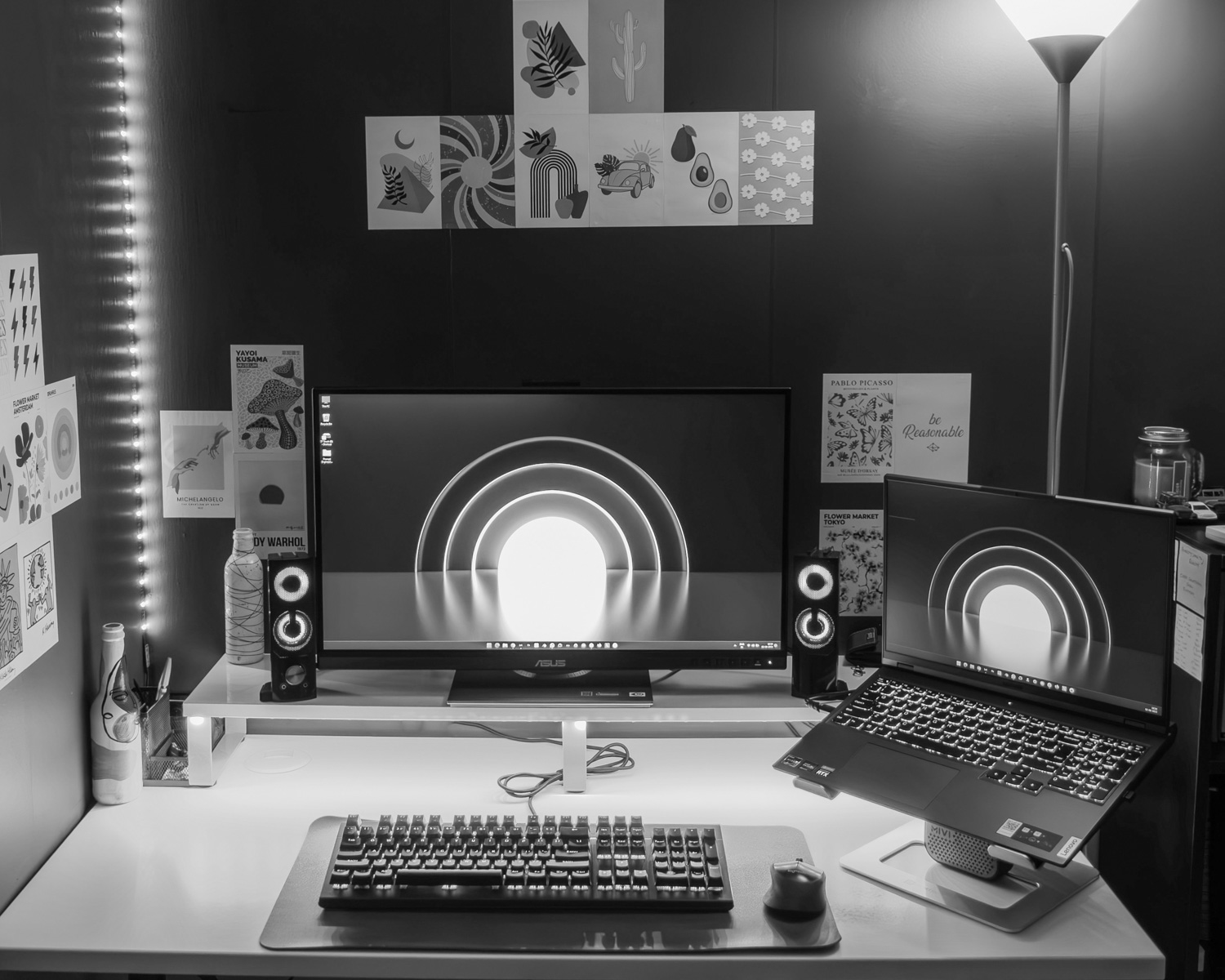 a desk with a laptop and a monitor on it