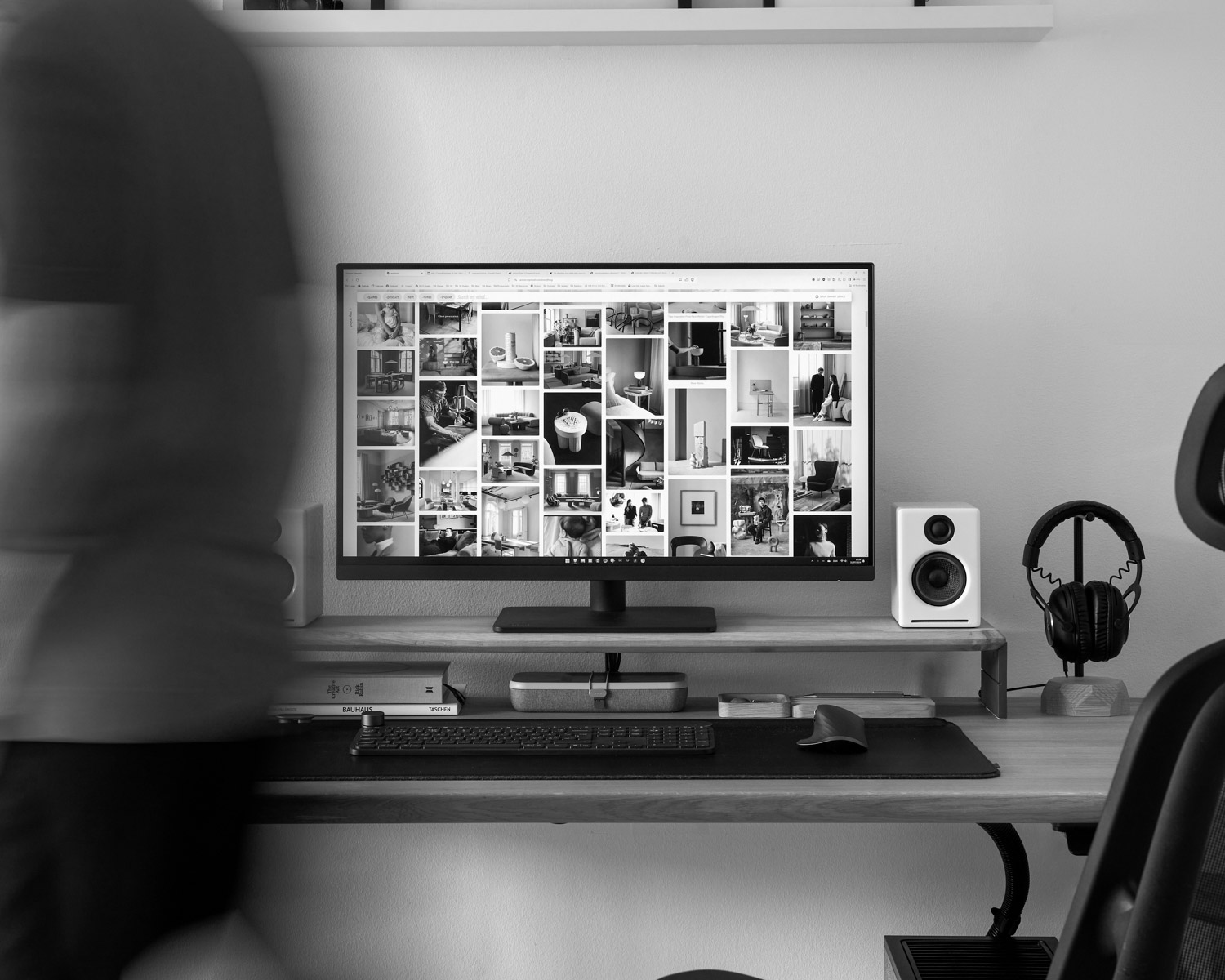 A blurry photo of a person standing in front of a computer