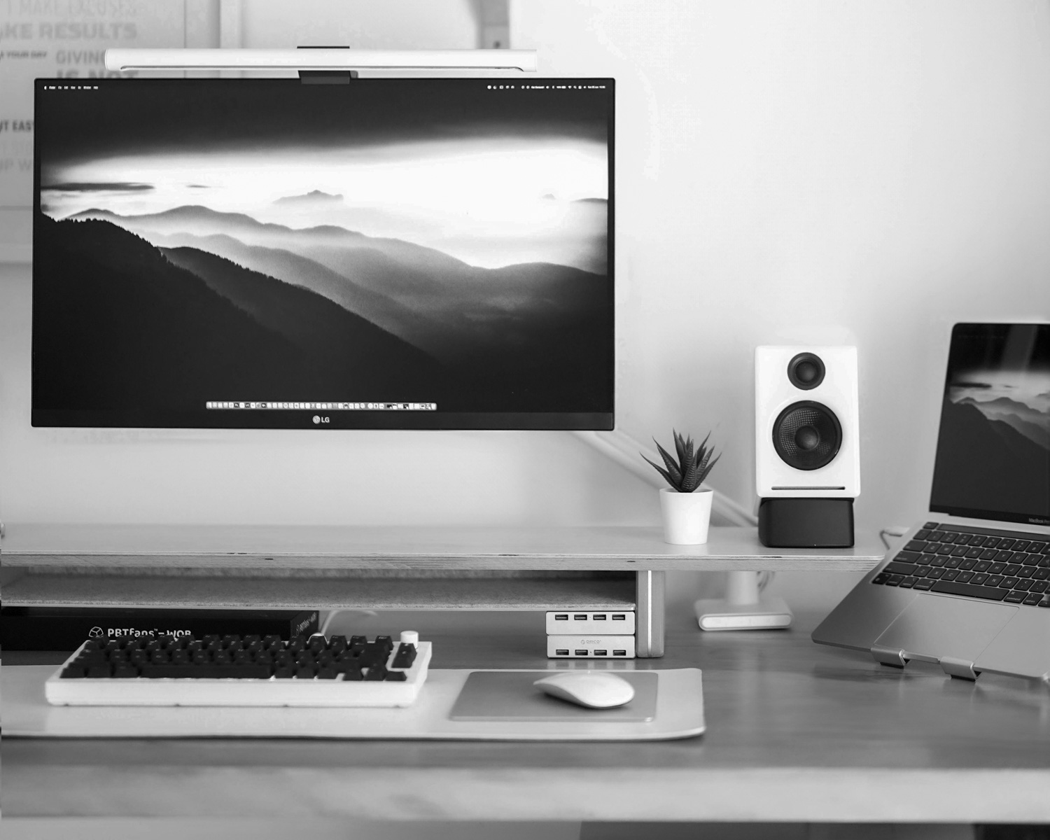 a desk with a laptop and a desktop computer on it