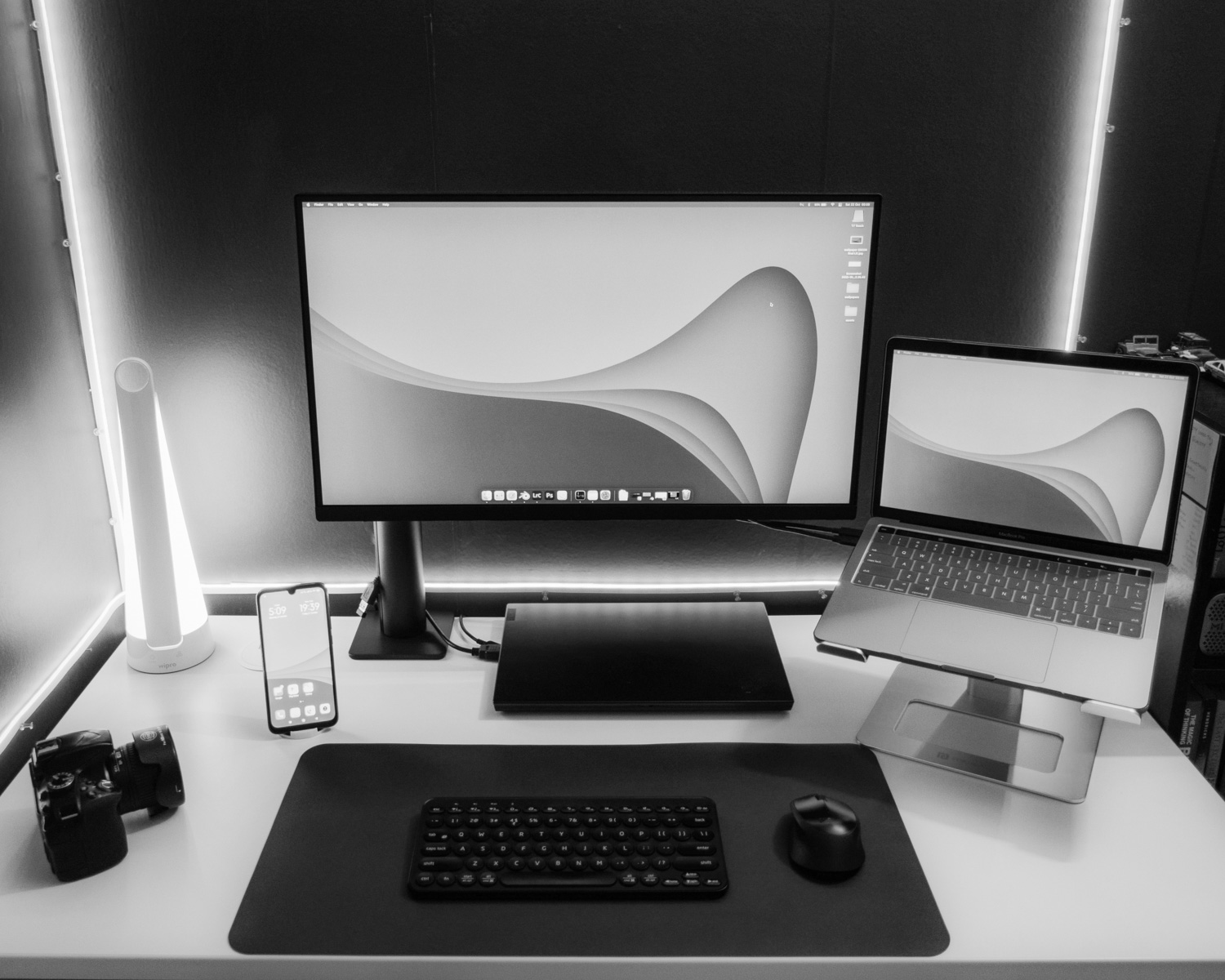 a desk with a laptop and a monitor