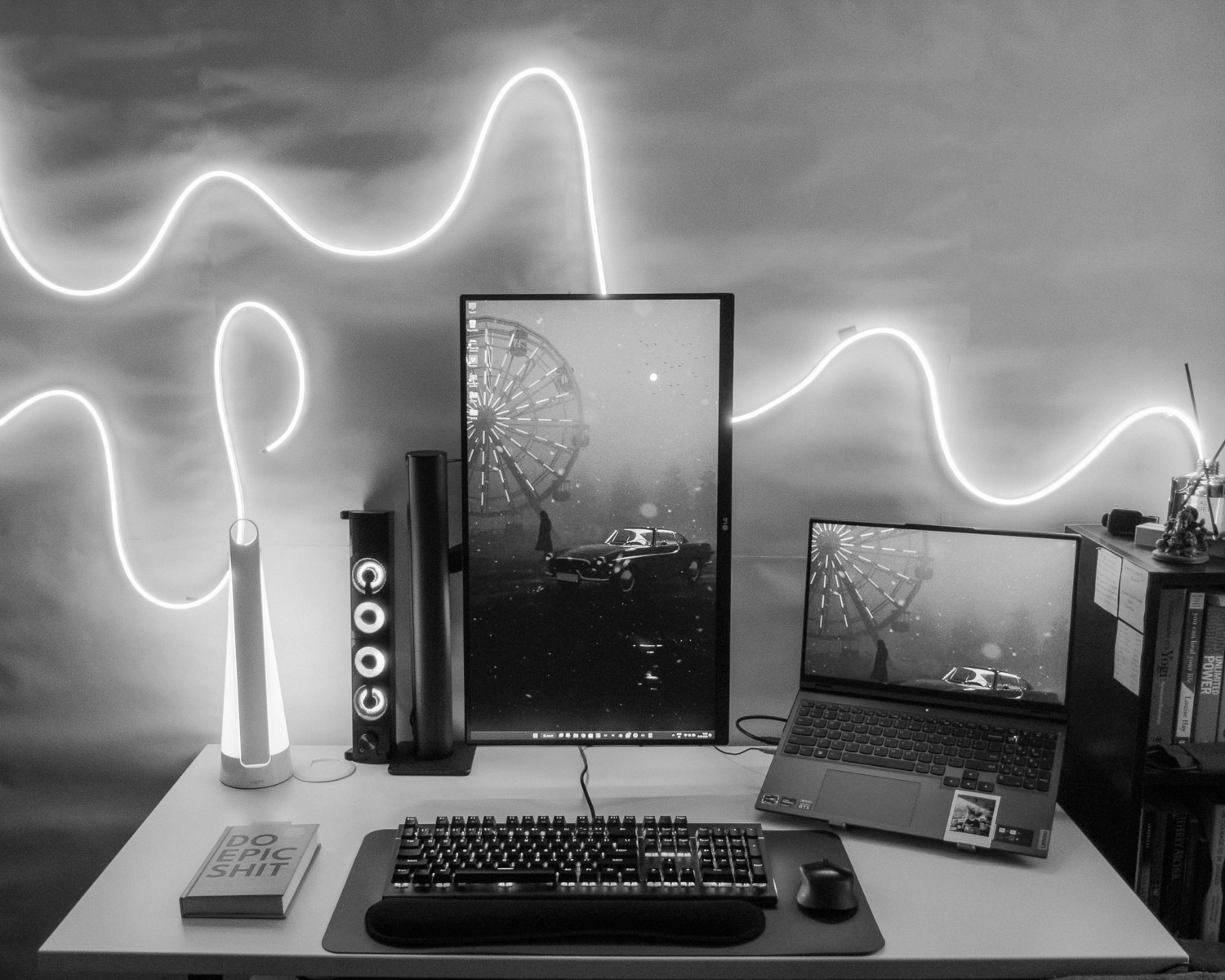a desk with a keyboard, monitor, mouse and other items