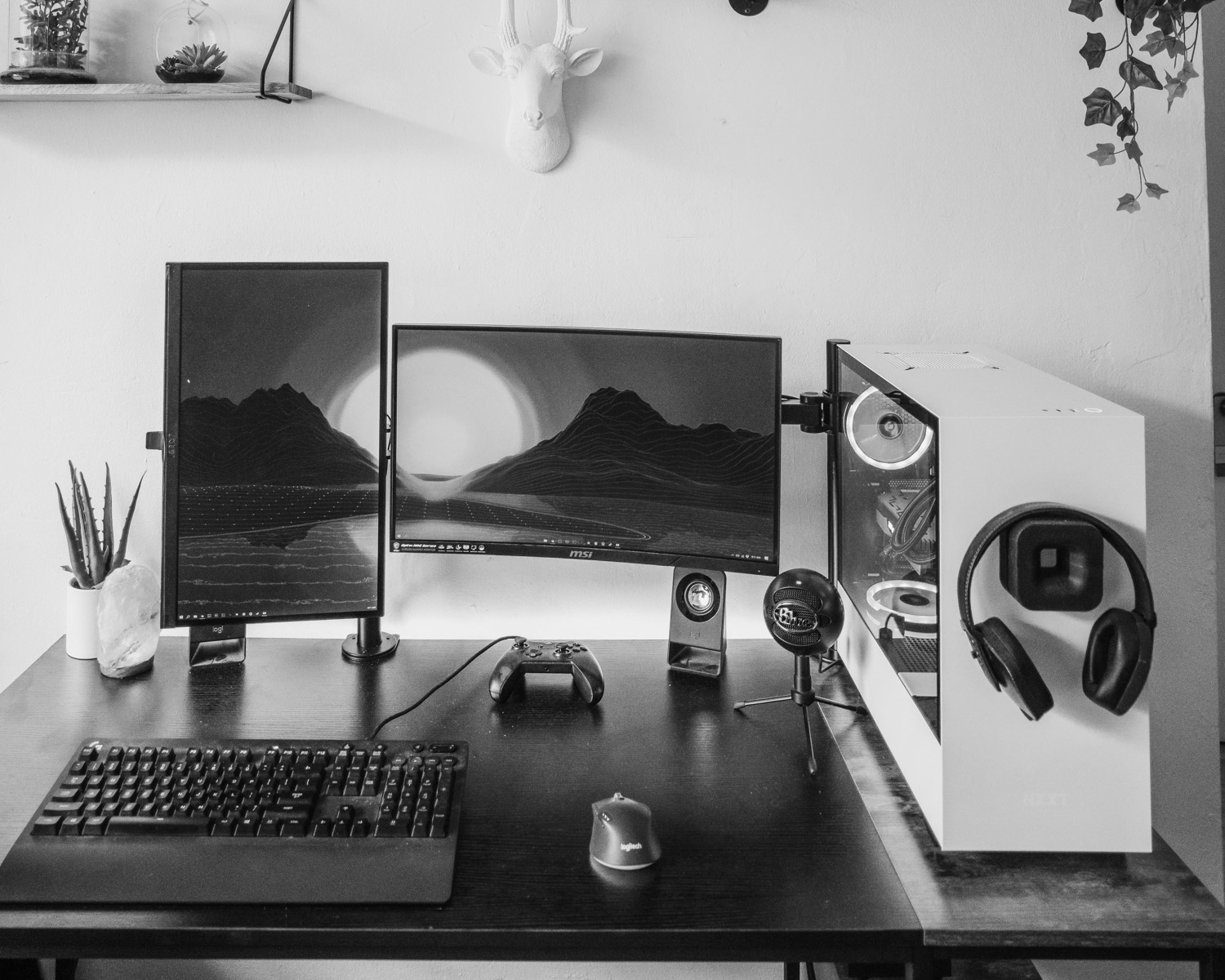 black flat screen computer monitor and keyboard on black wooden desk