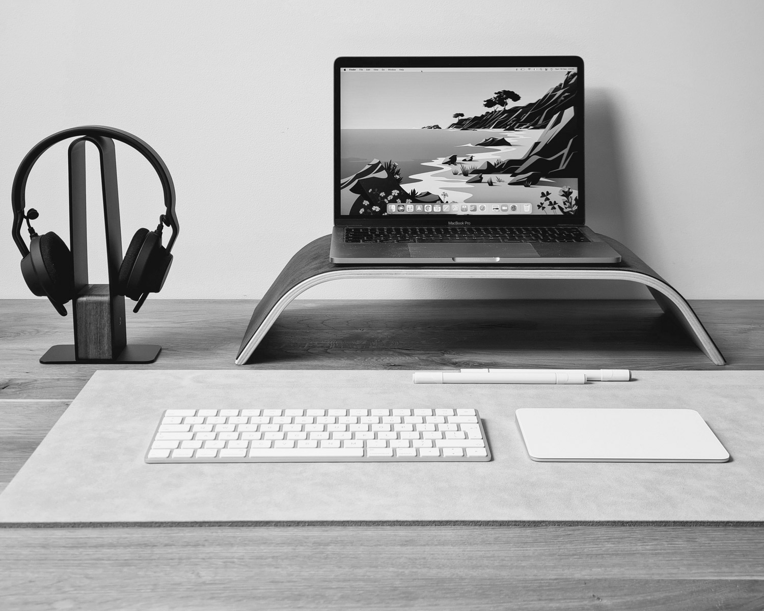 a laptop computer sitting on top of a wooden desk