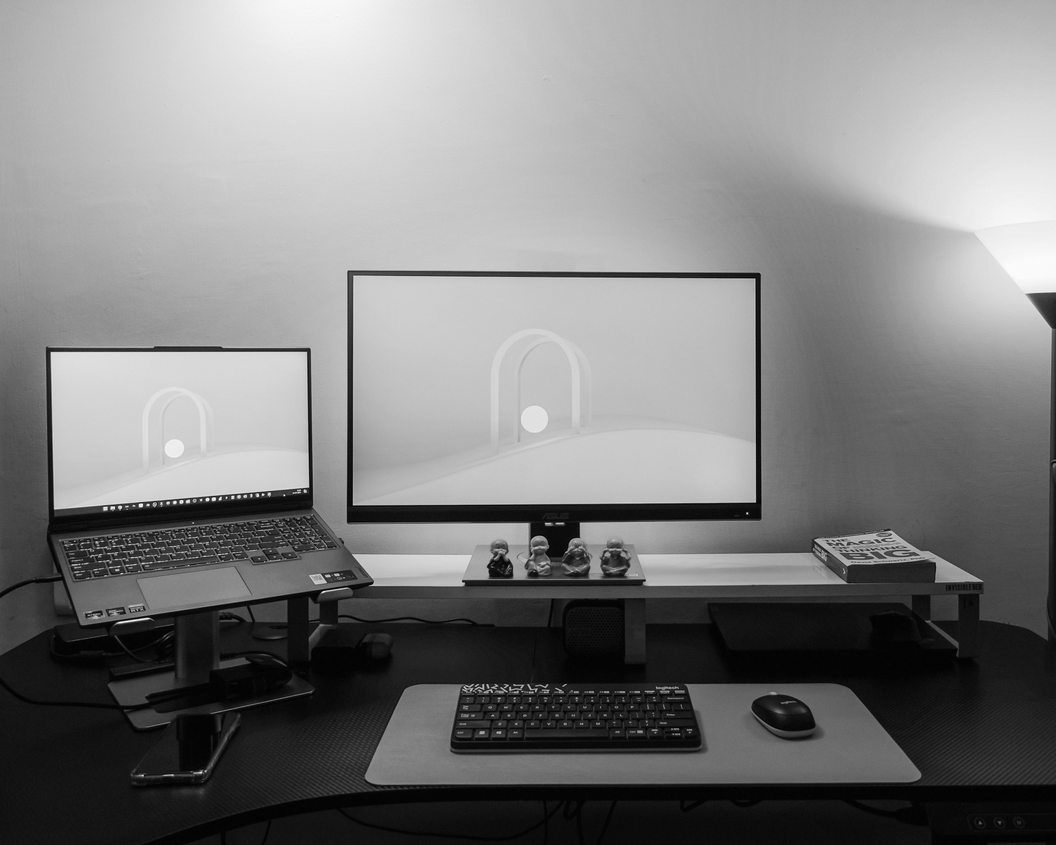 a desk with a laptop and a monitor on it