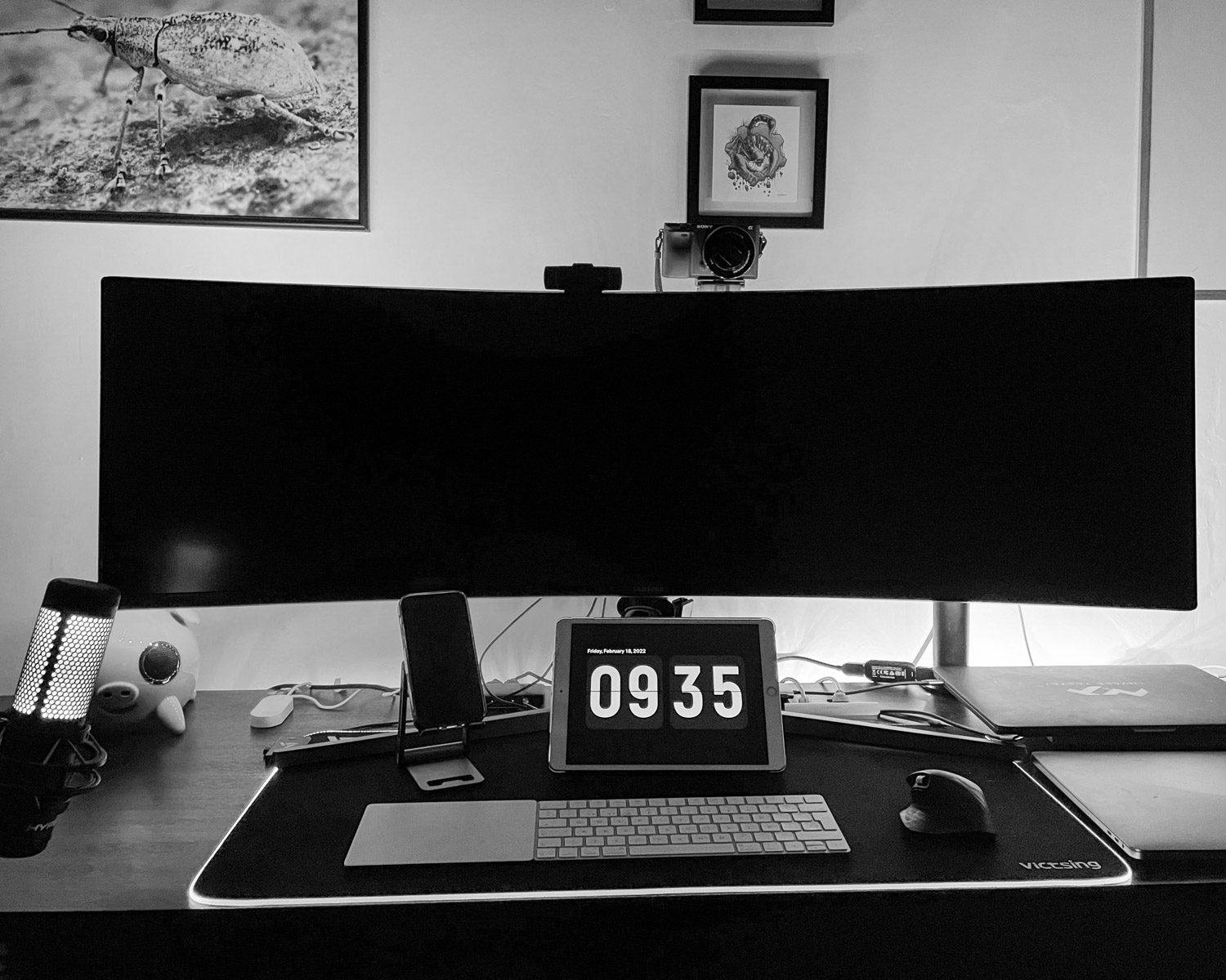 a desk with a laptop and a clock on it