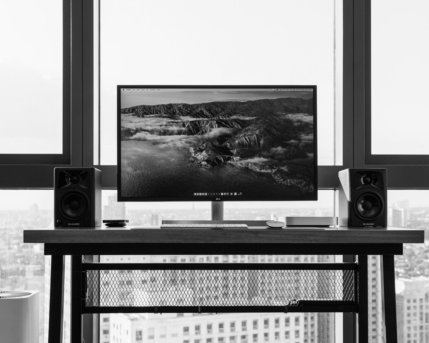 a computer monitor sitting on top of a wooden desk
