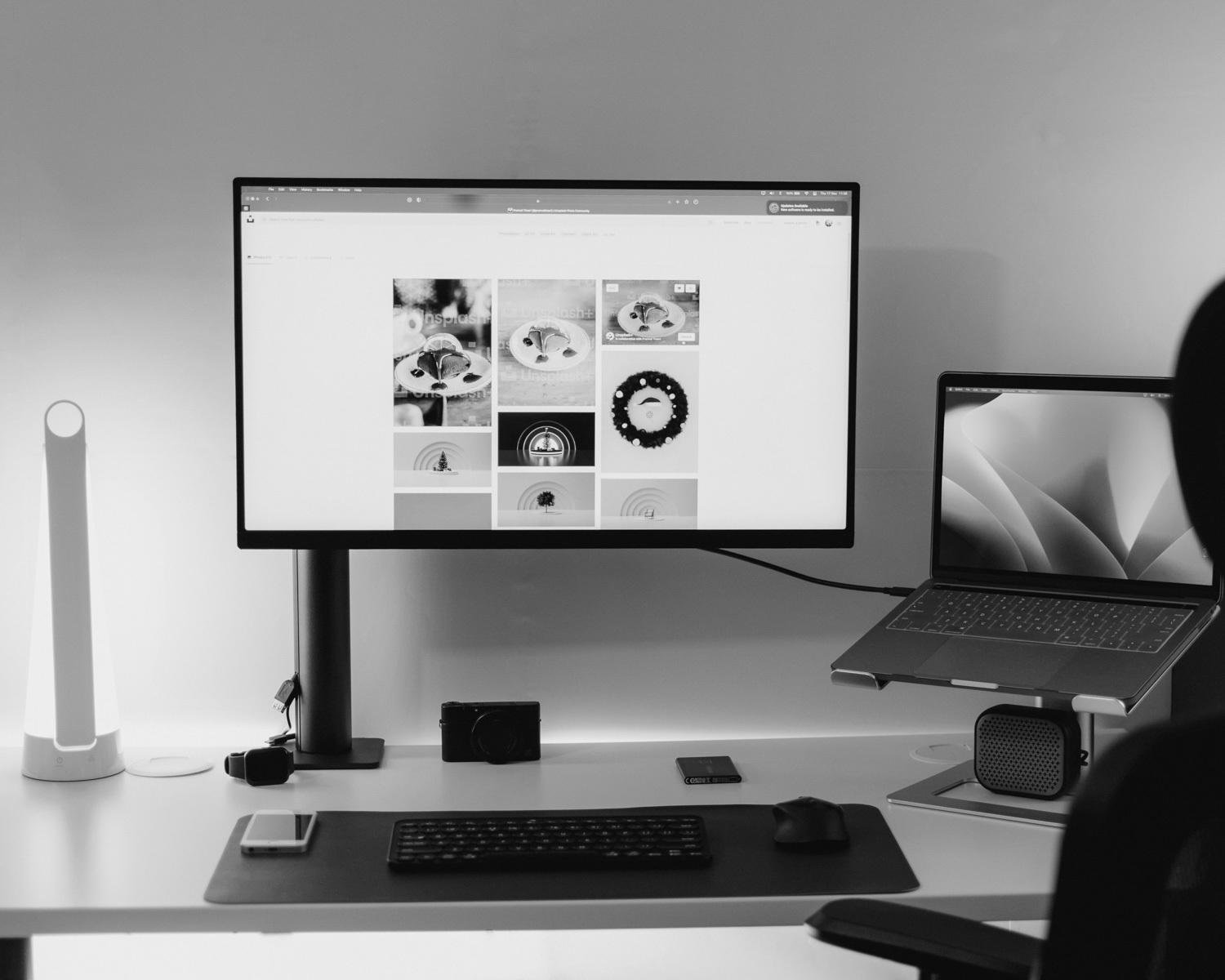 a desk with a laptop and a monitor