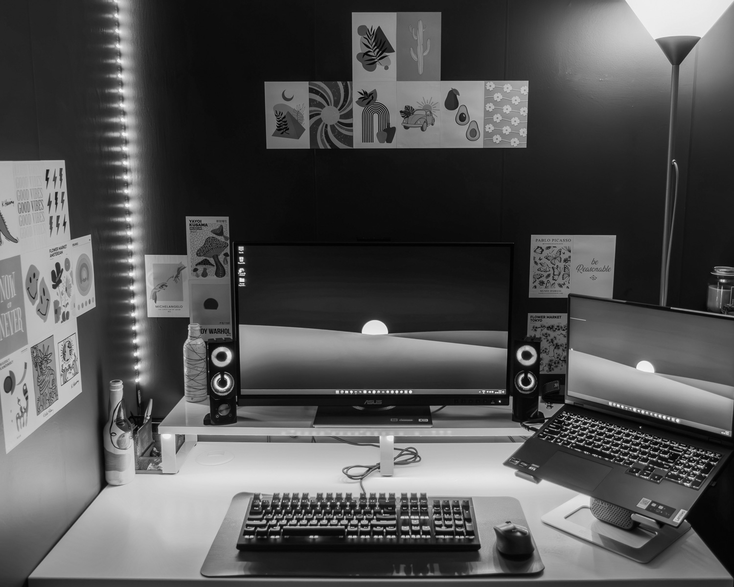 a desk with a laptop, keyboard and monitor on it