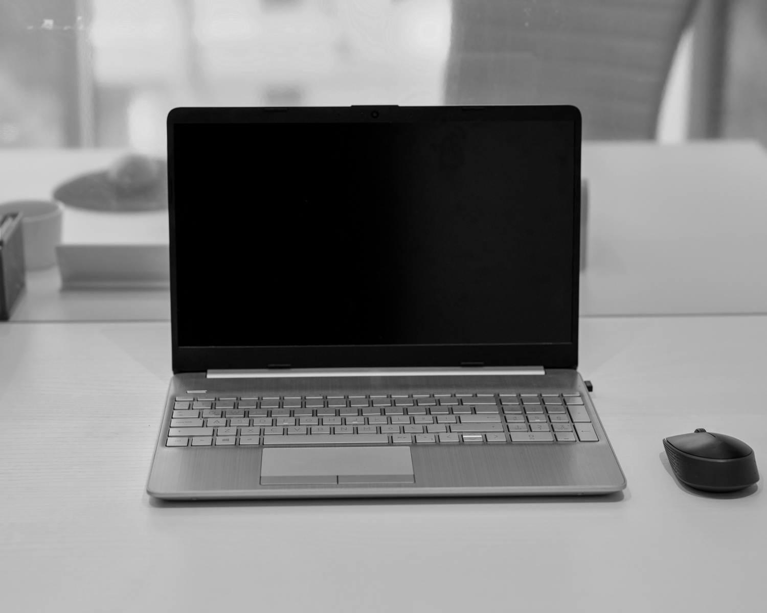 a laptop computer sitting on top of a white desk