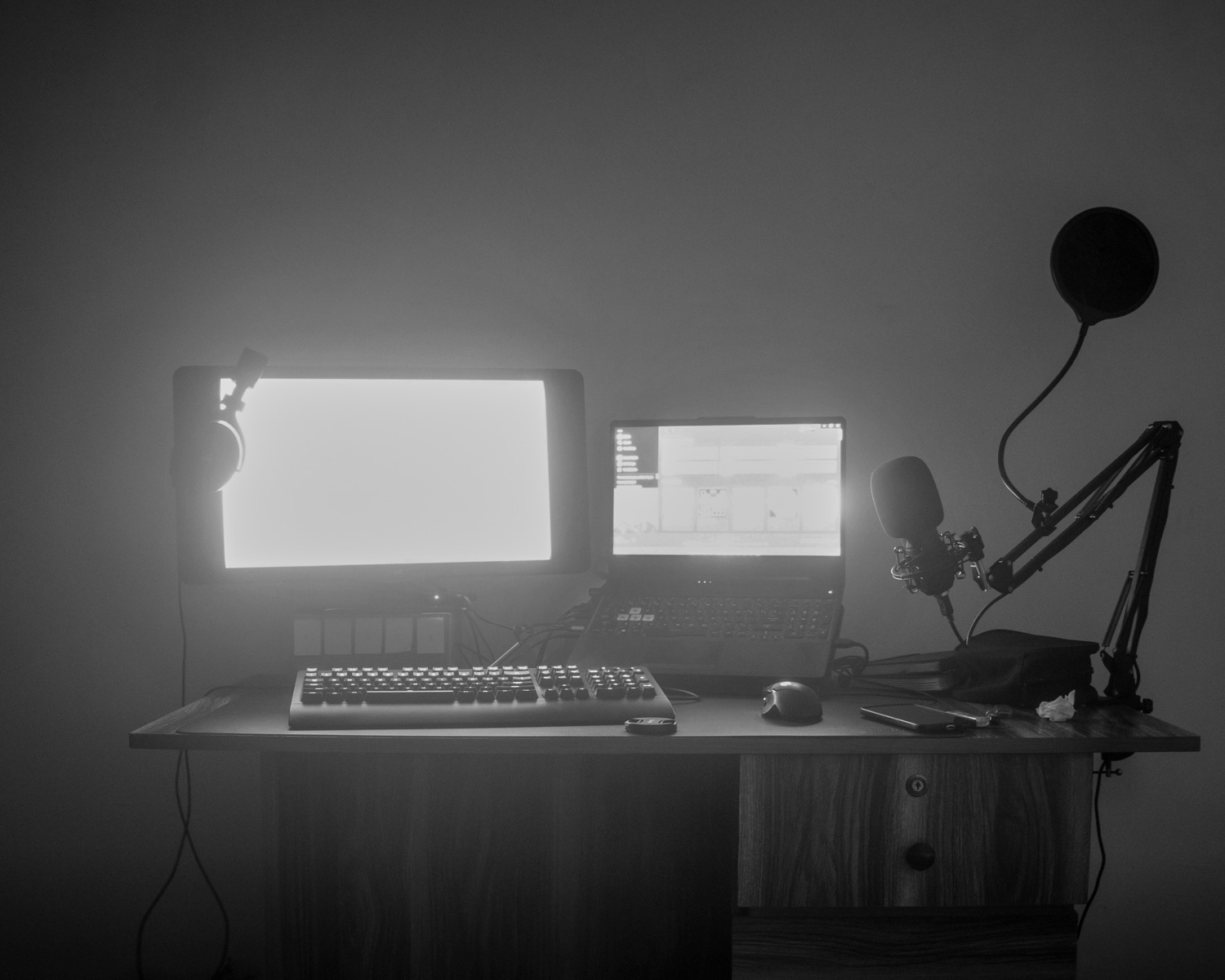 a desk with a computer and a microphone on it