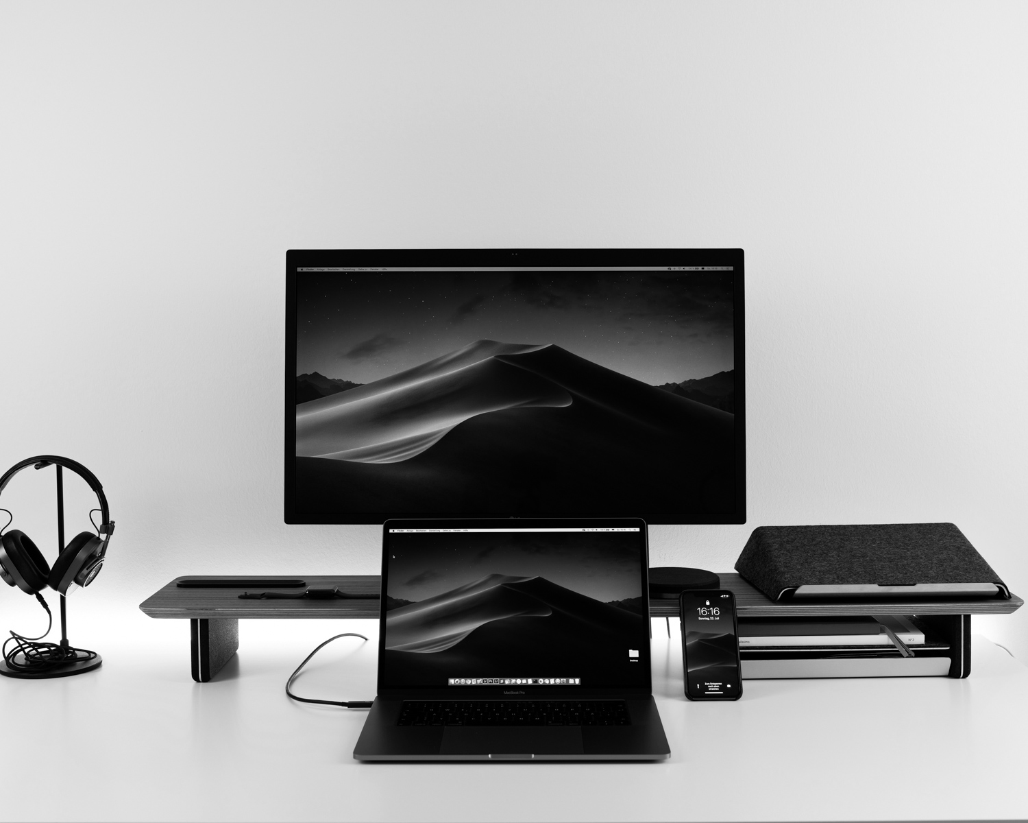 black laptop computer under black flat screen TV