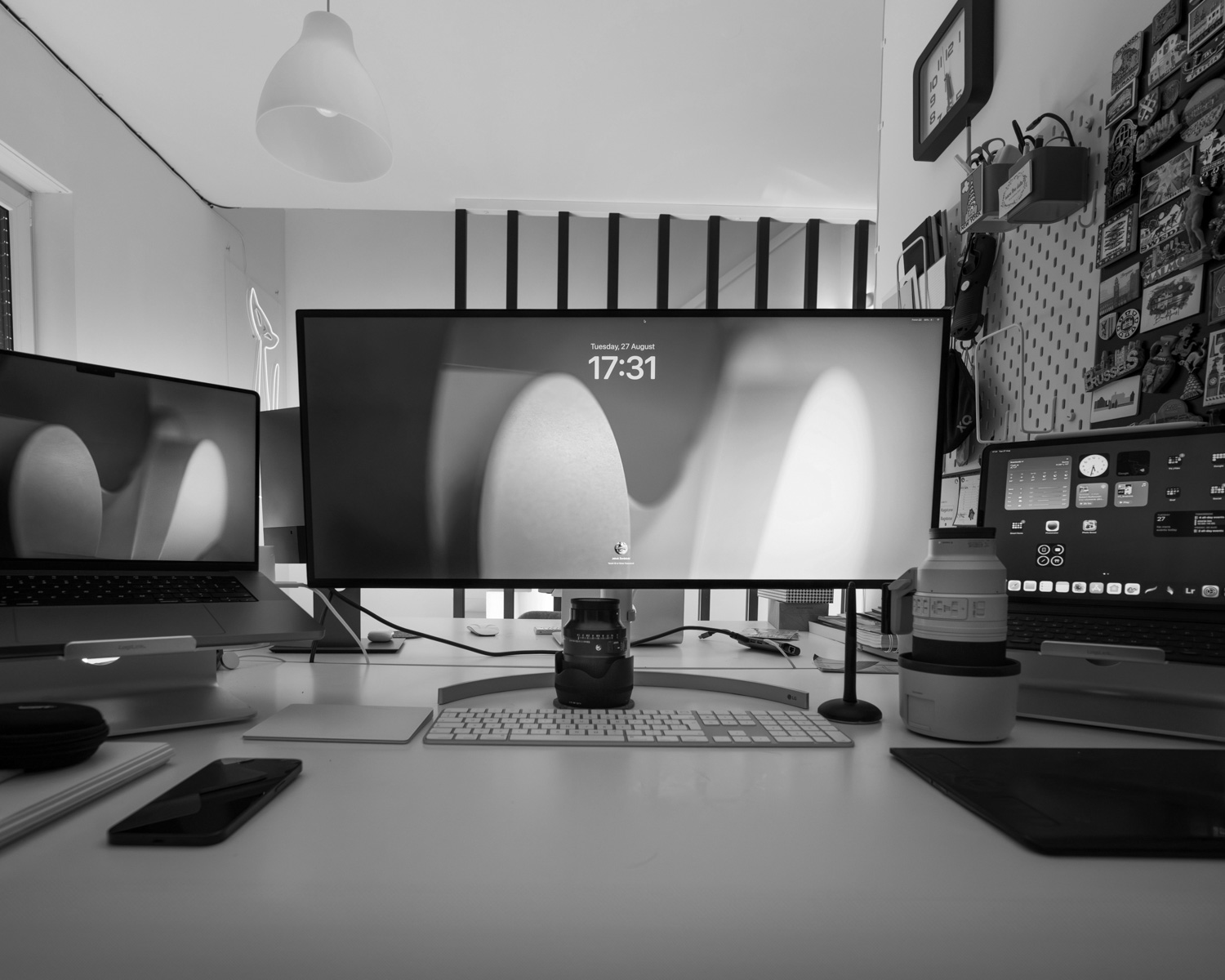 Three computer monitors sitting on top of a desk