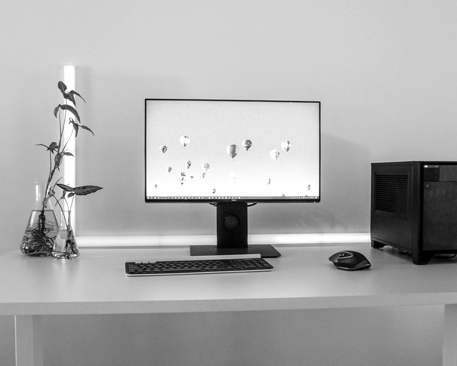 black flat screen computer monitor, black wireless computer mouse, and black wireless computer keyboard