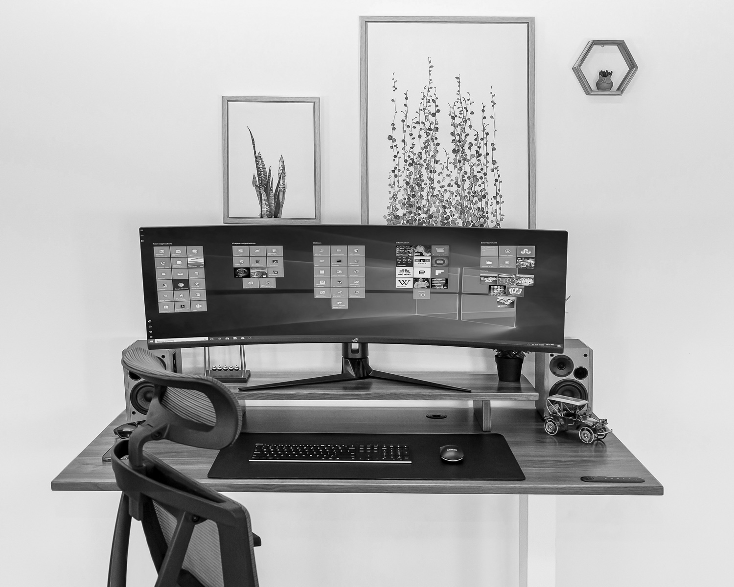 a computer monitor sitting on top of a wooden desk