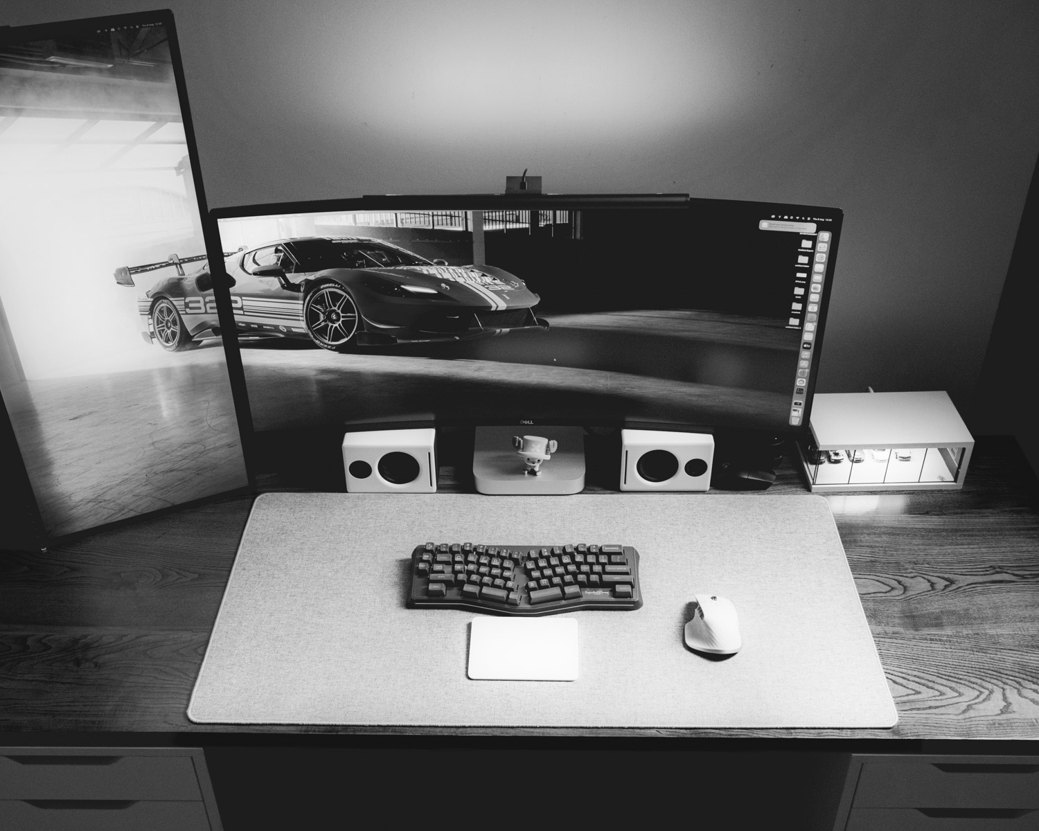 A computer desk with a monitor and keyboard