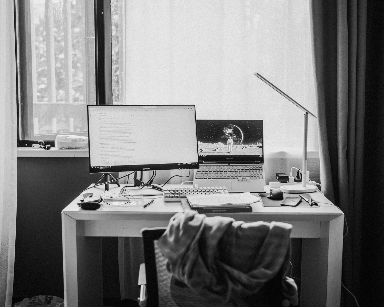 a desk with a computer and a laptop on it