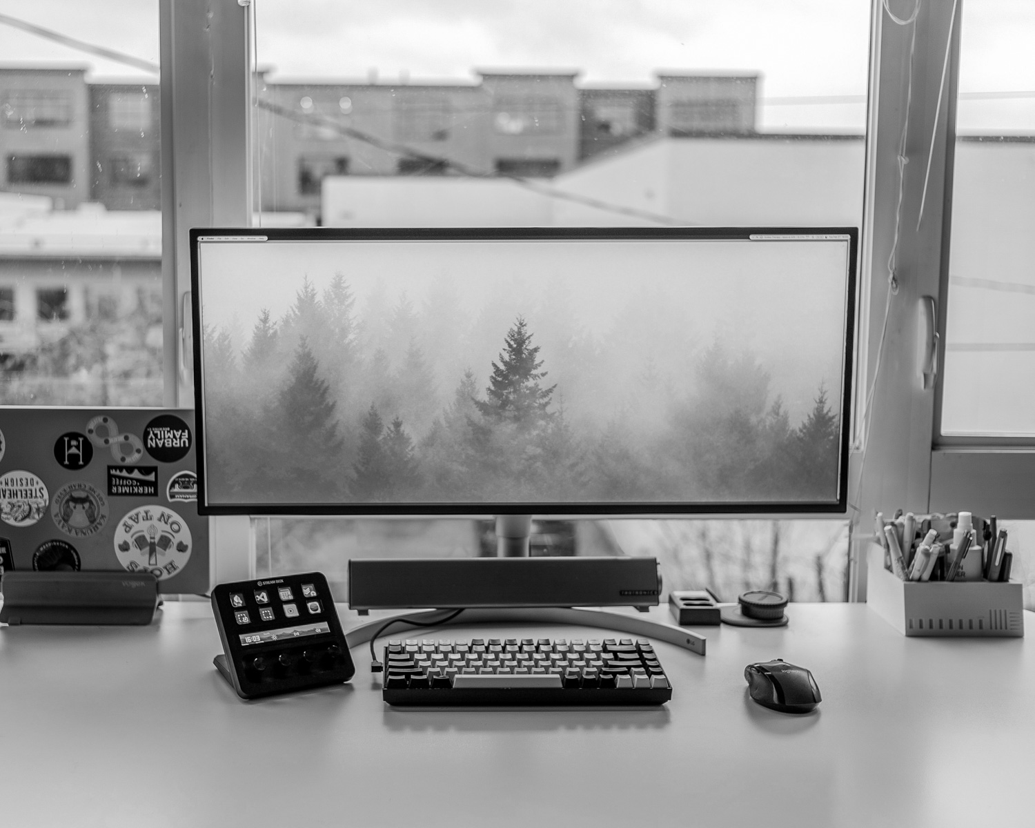 a desk with a computer monitor, keyboard and mouse