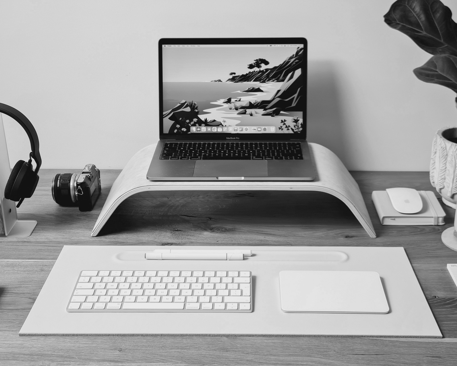 a laptop computer sitting on top of a wooden desk