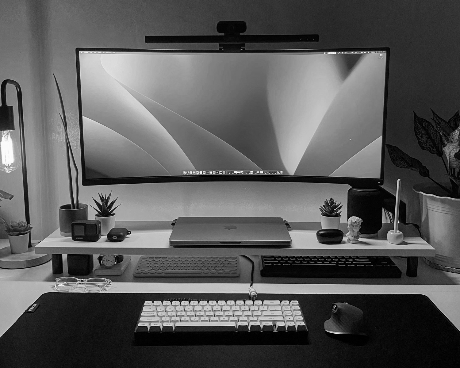 a desk with a monitor, keyboard and mouse