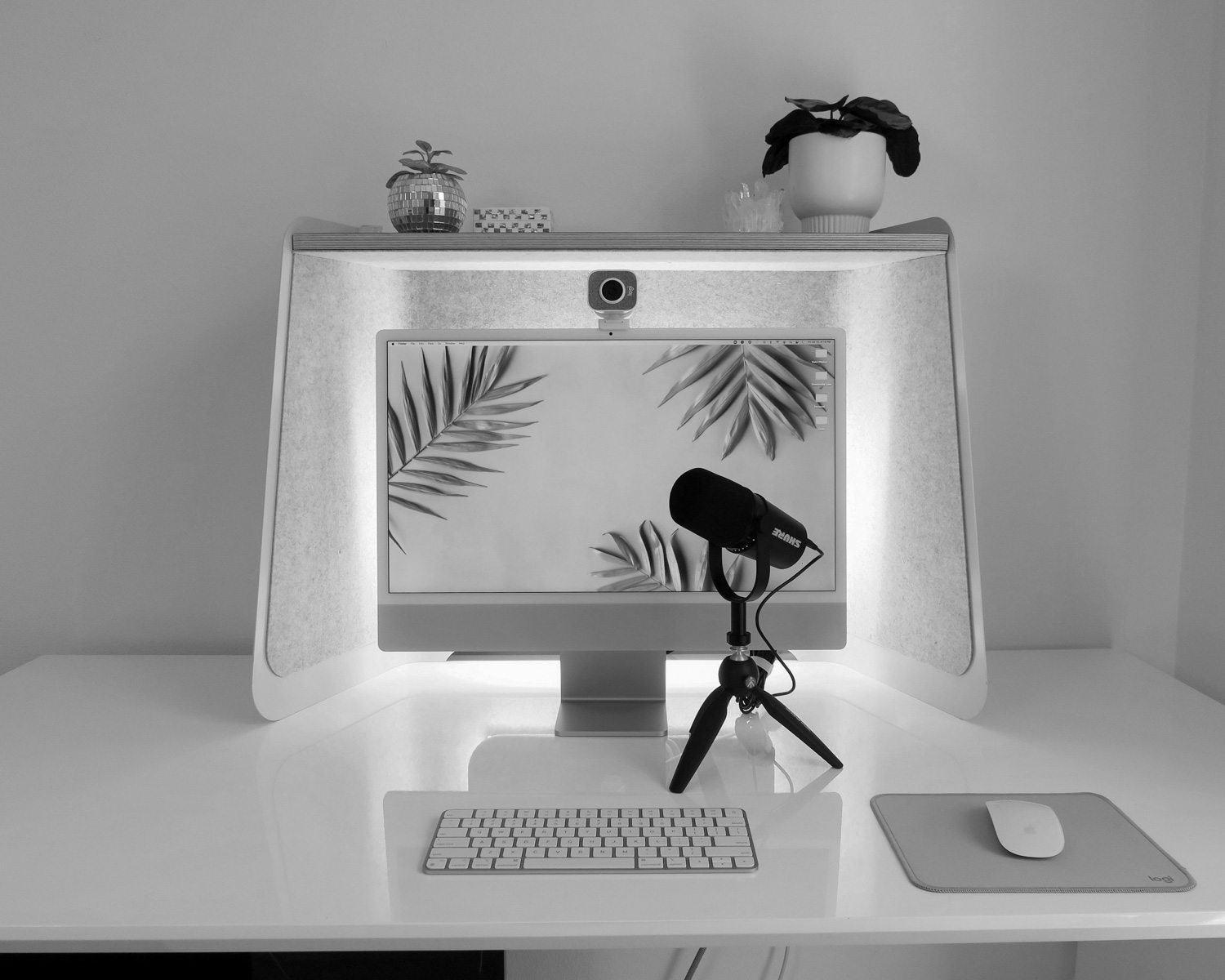 a computer monitor and a toy figure