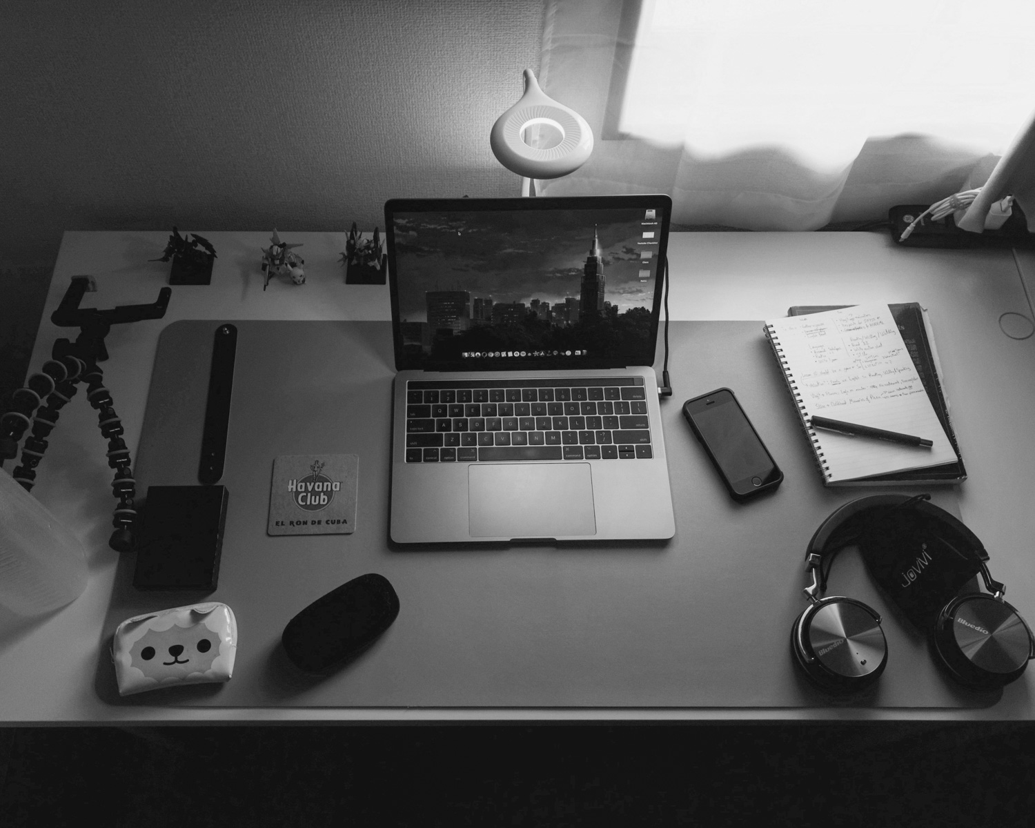 MacBook Pro beside black smartphone and notebook