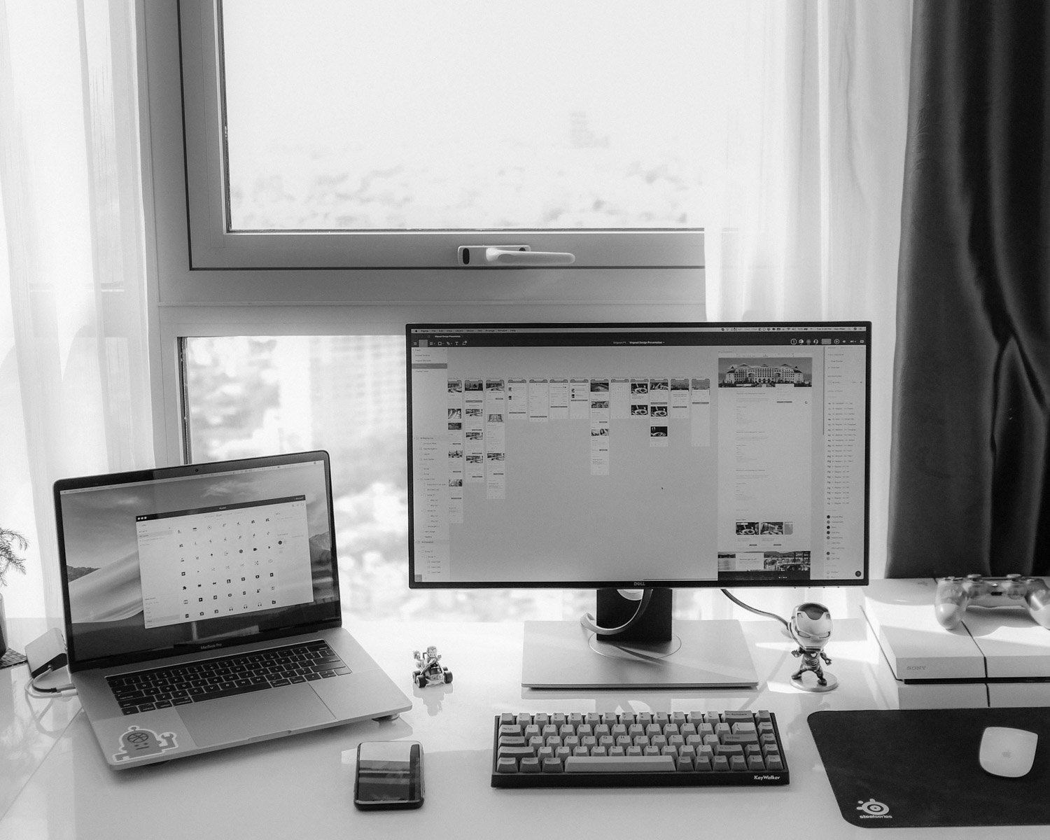 flat screen computer monitor and MacBook Pro near window