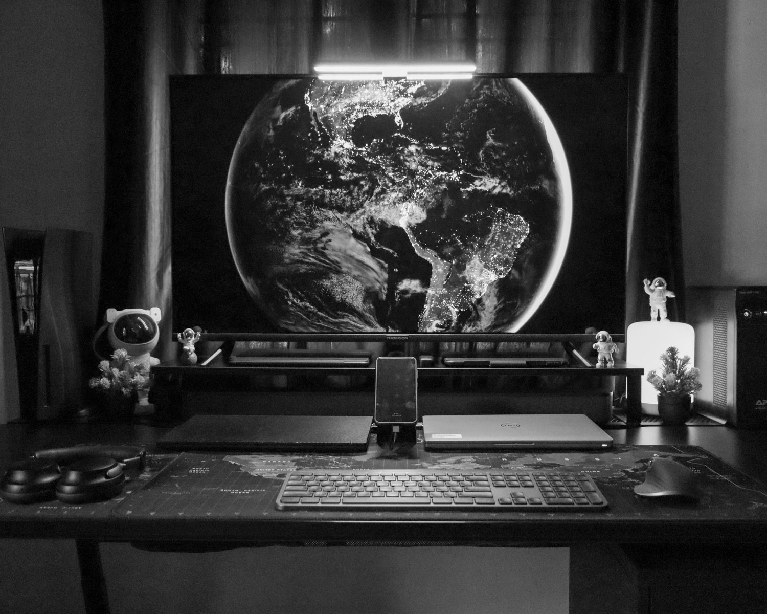 A desk with a monitor and keyboard on it