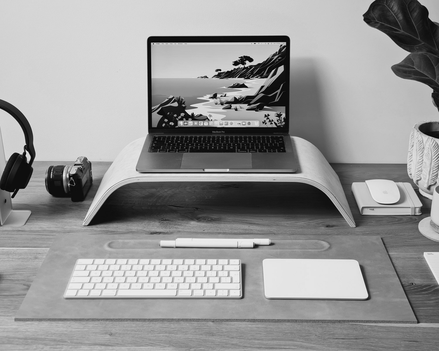 a laptop computer sitting on top of a wooden desk