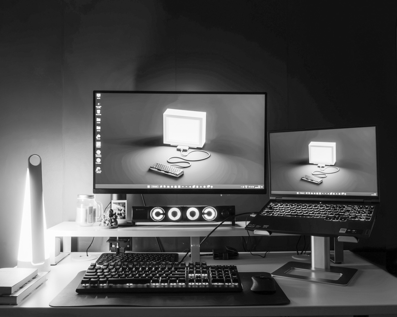 a desk with two monitors and a keyboard