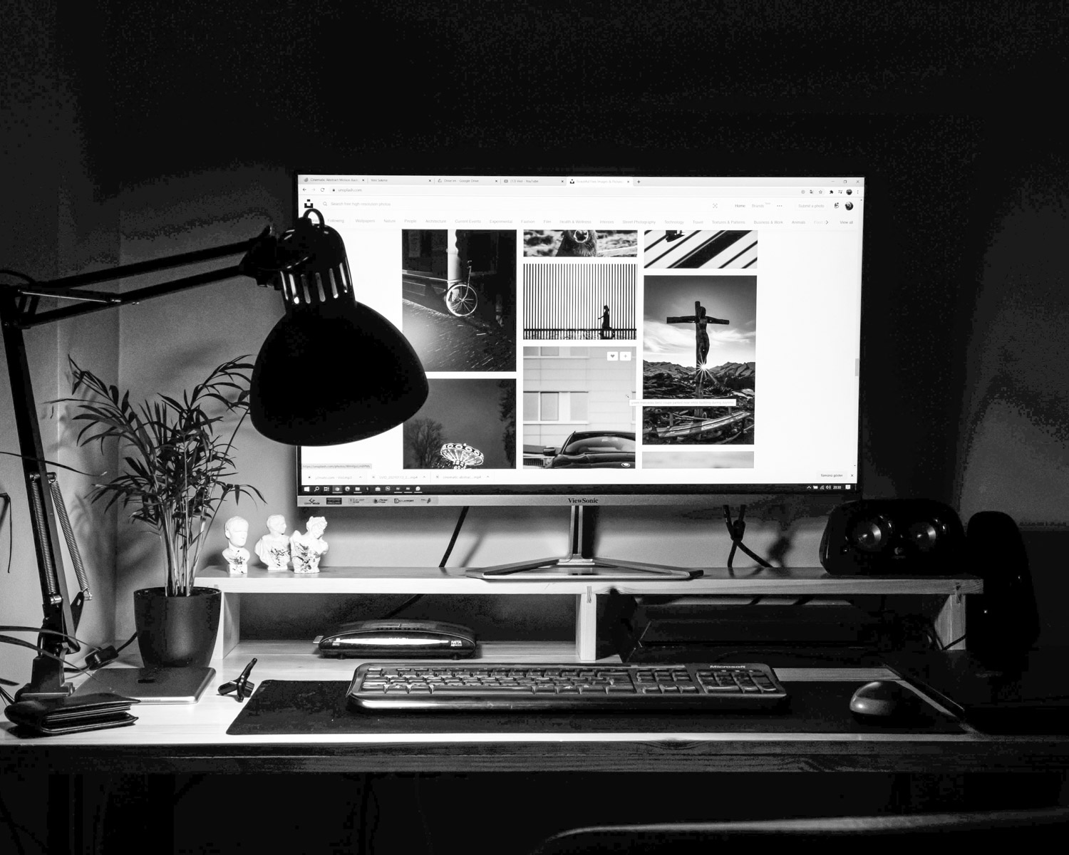 black flat screen computer monitor on brown wooden desk