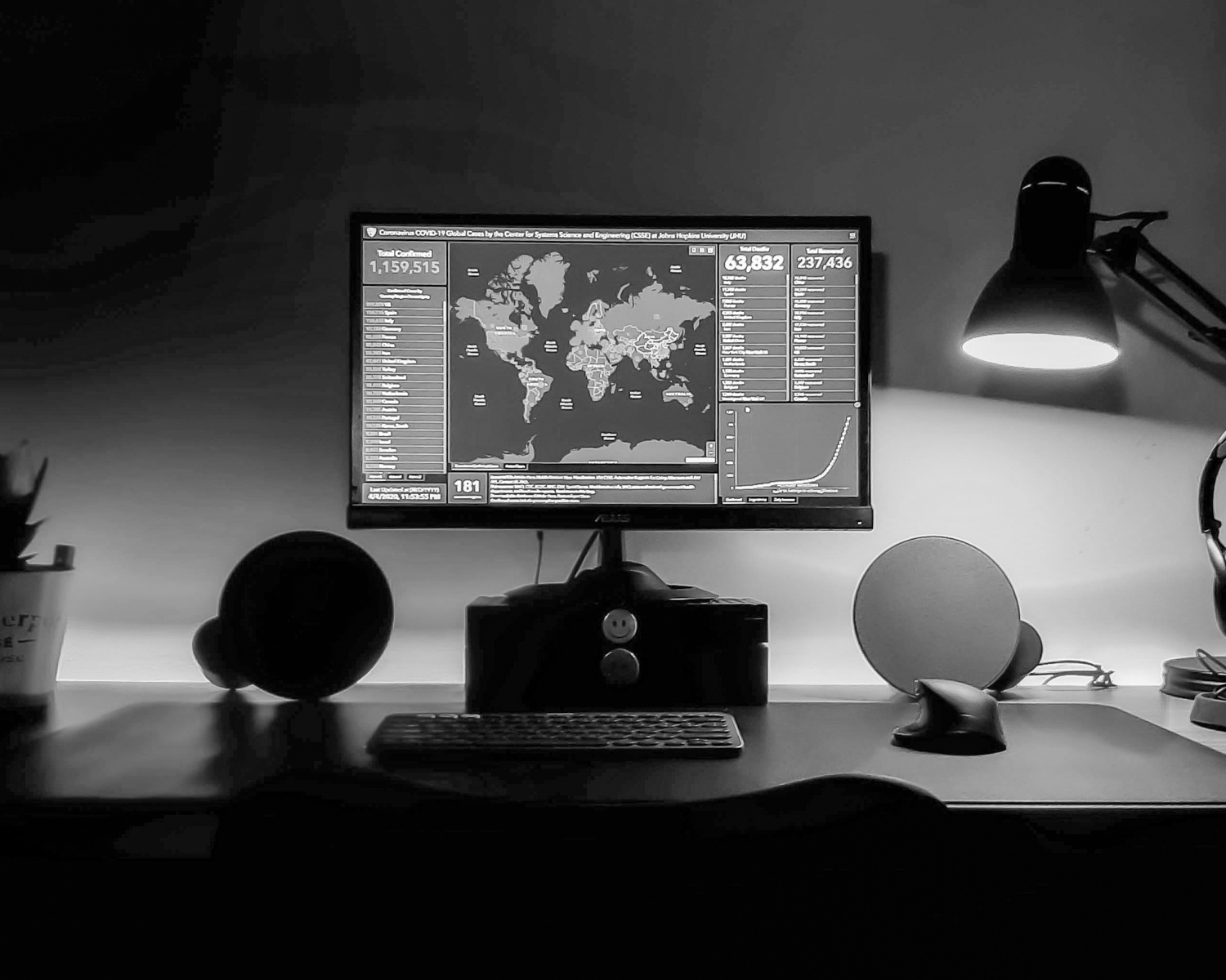 black flat screen computer monitor on brown wooden desk