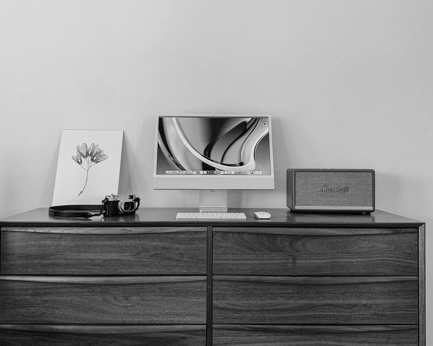a computer monitor sitting on top of a wooden dresser