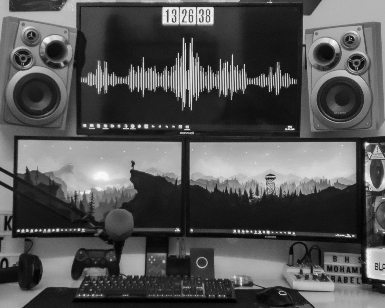 black flat screen computer monitor turned on beside black and silver speaker