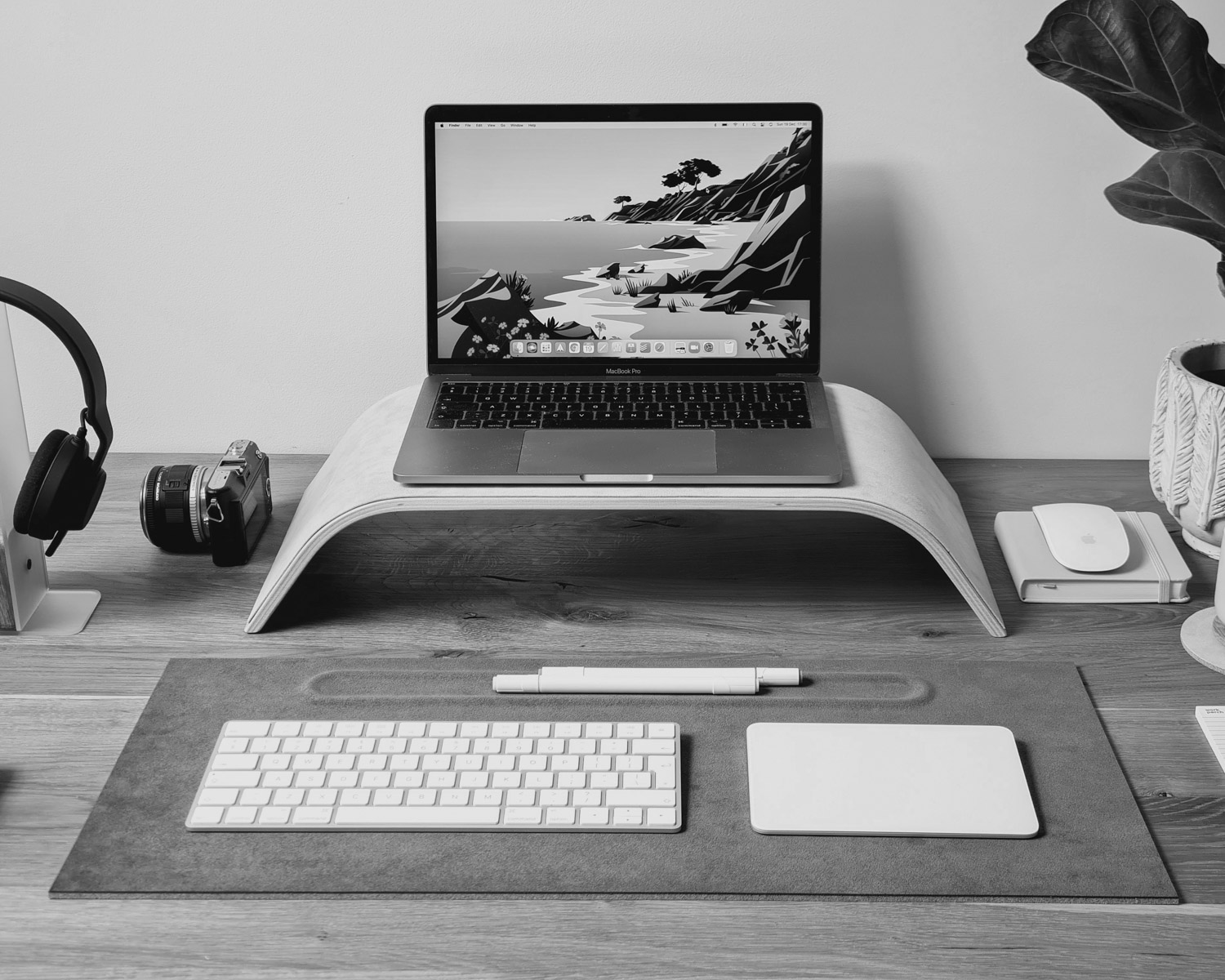 a laptop computer sitting on top of a wooden desk