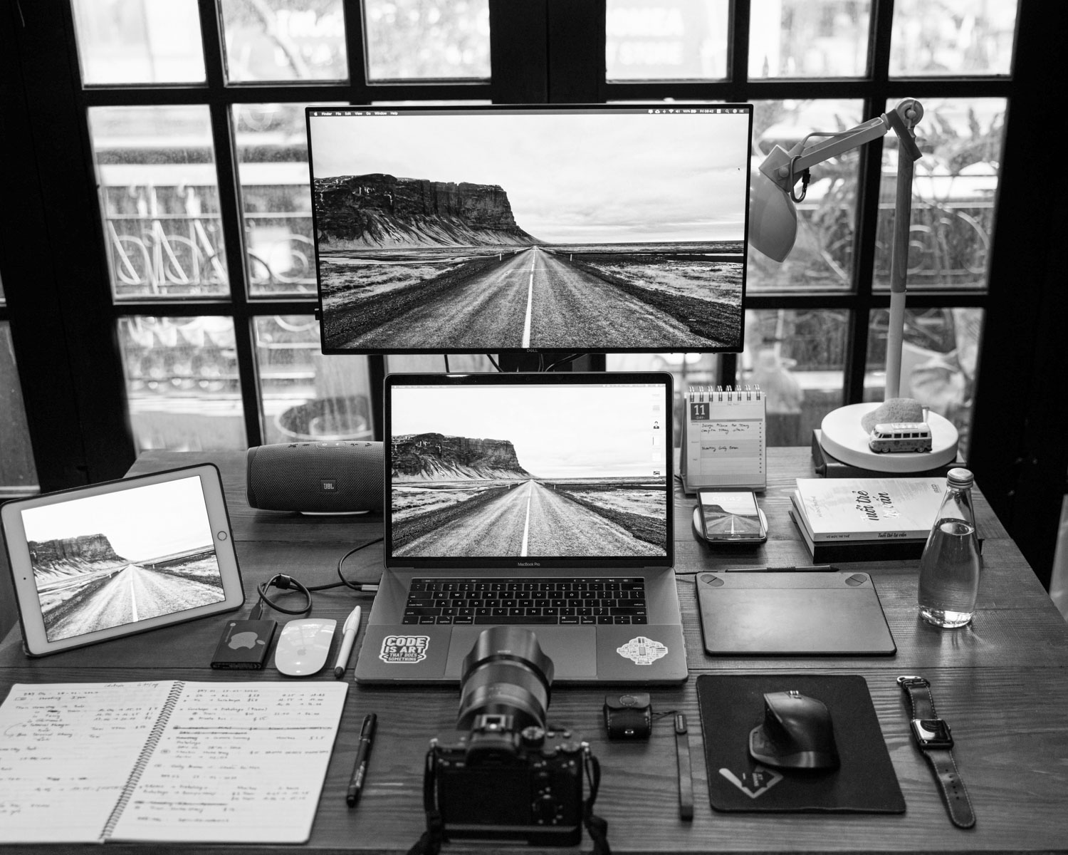 black laptop computer on brown wooden table