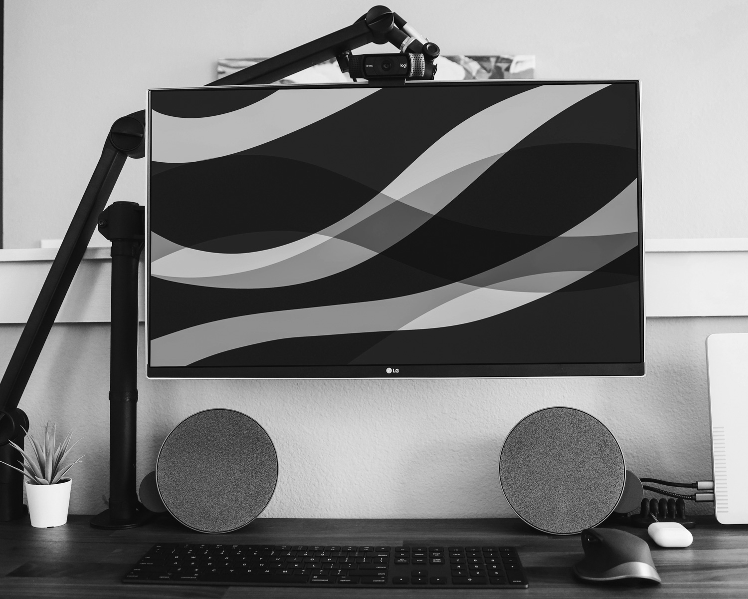 flat screen monitor beside wall and pair of gray speakers
