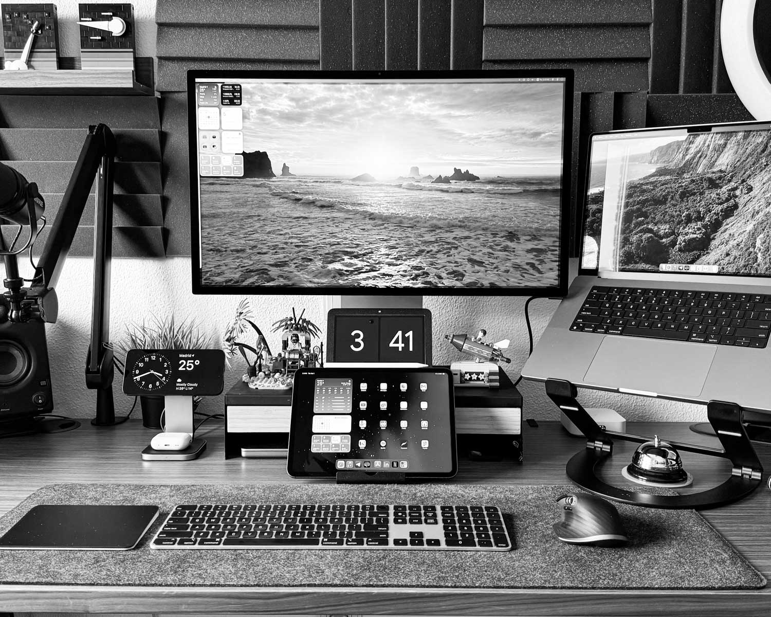 A desk with two monitors and a camera