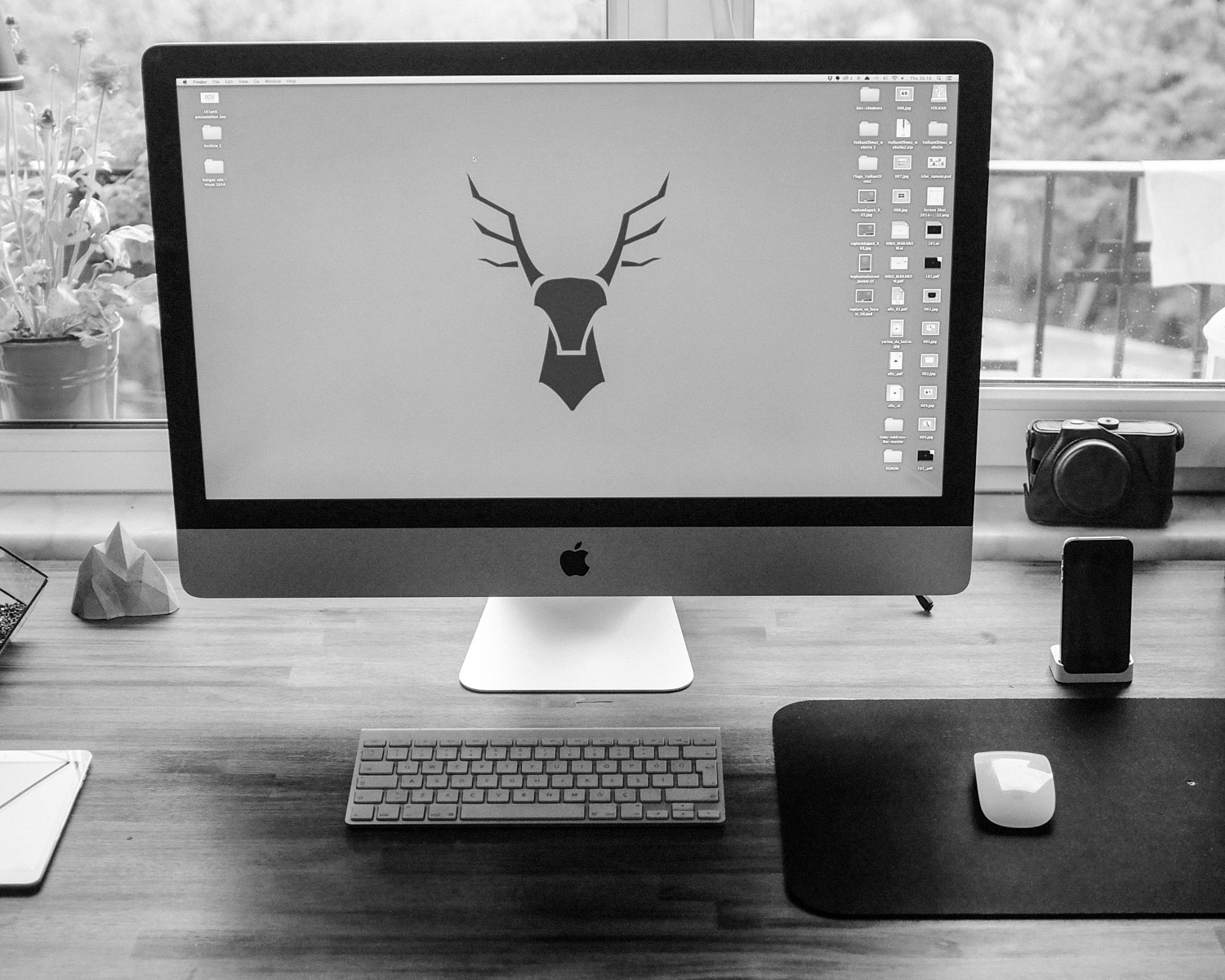 silver iMac on brown wooden table