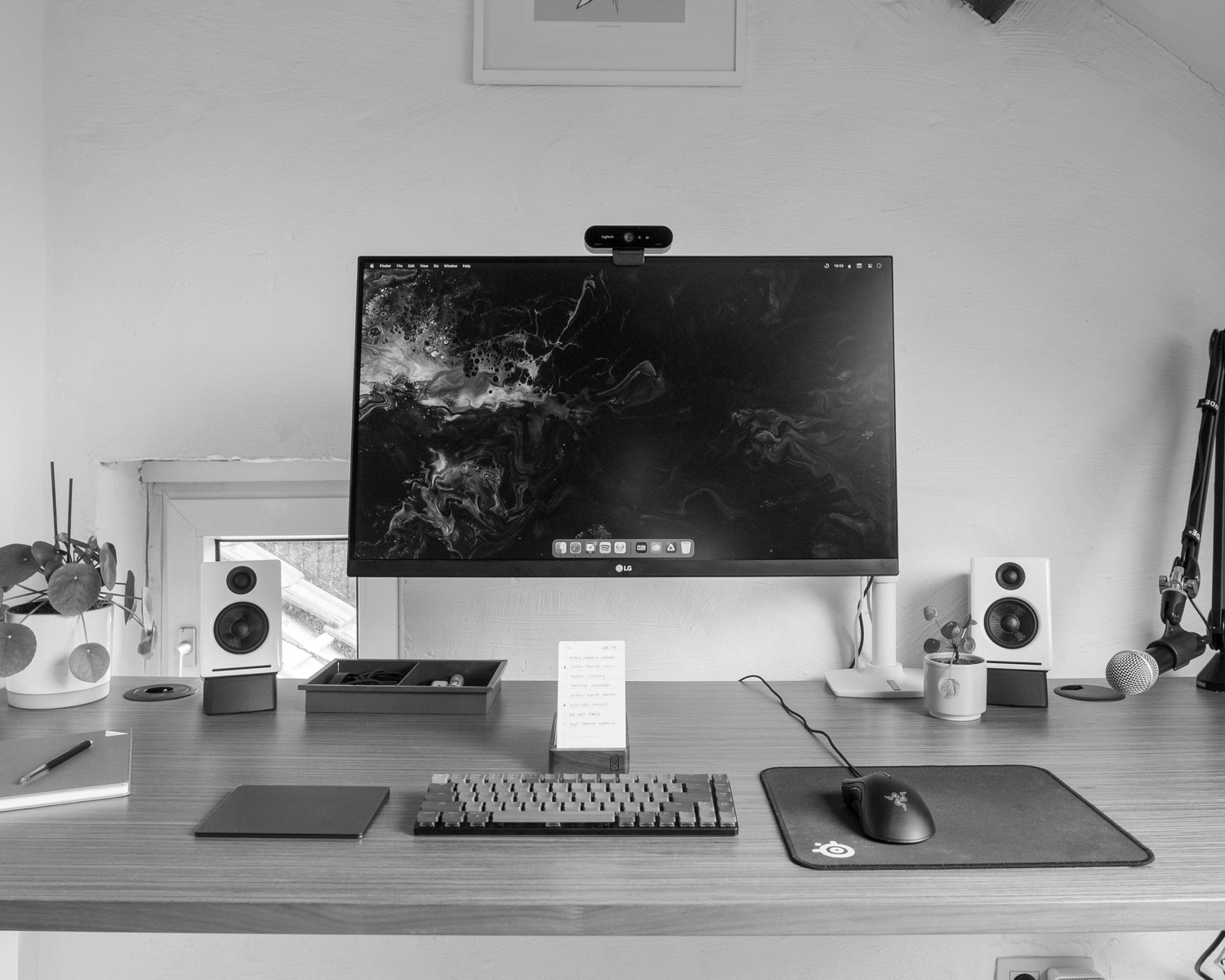 a computer monitor sitting on top of a wooden desk