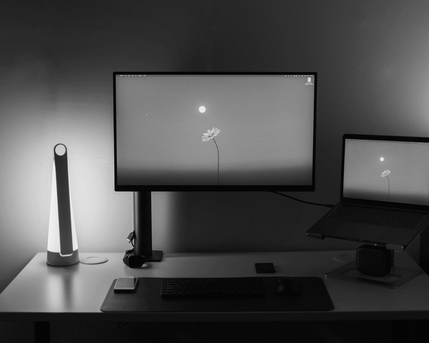 a desk with a laptop and a monitor on it