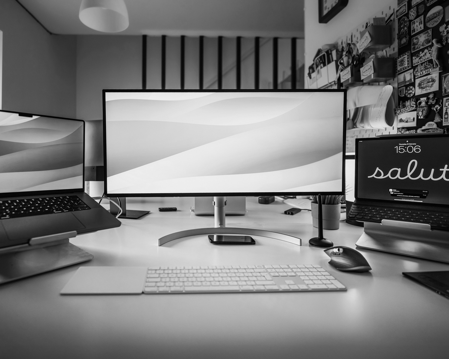 a desk with three computer monitors and a keyboard